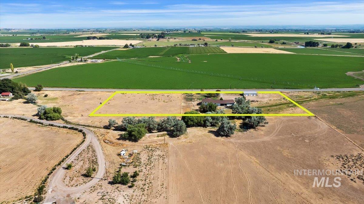 View of rural area featuring property boundaries highlighted and large plots for crops
