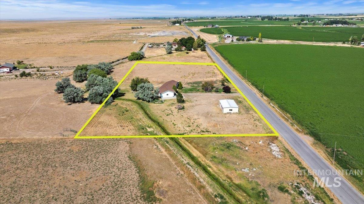 Aerial view of sparsely populated area featuring property boundaries highlighted