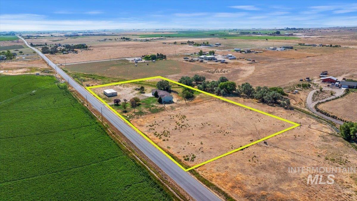 Aerial view of sparsely populated area featuring property boundaries highlighted