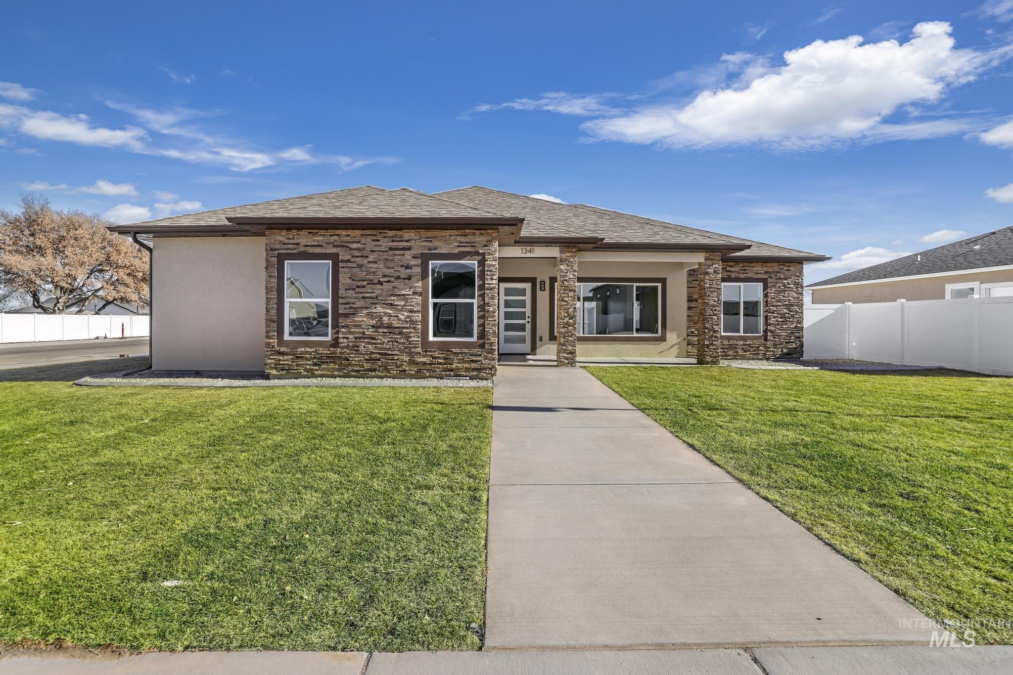 Prairie-style home featuring stone siding and stucco siding