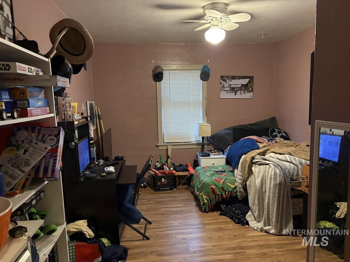Bedroom with light wood-style floors and ceiling fan
