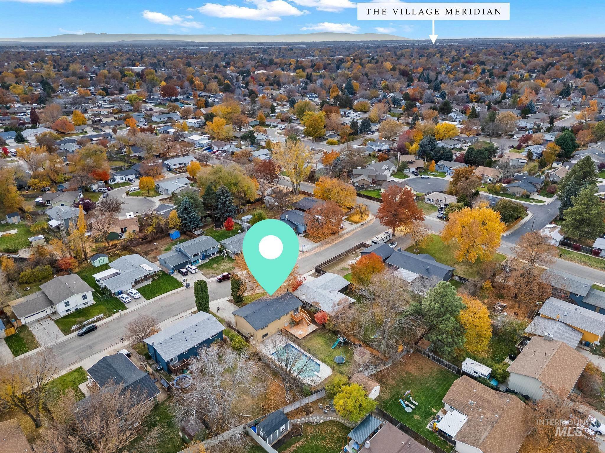 Aerial view of property's location with nearby suburban area