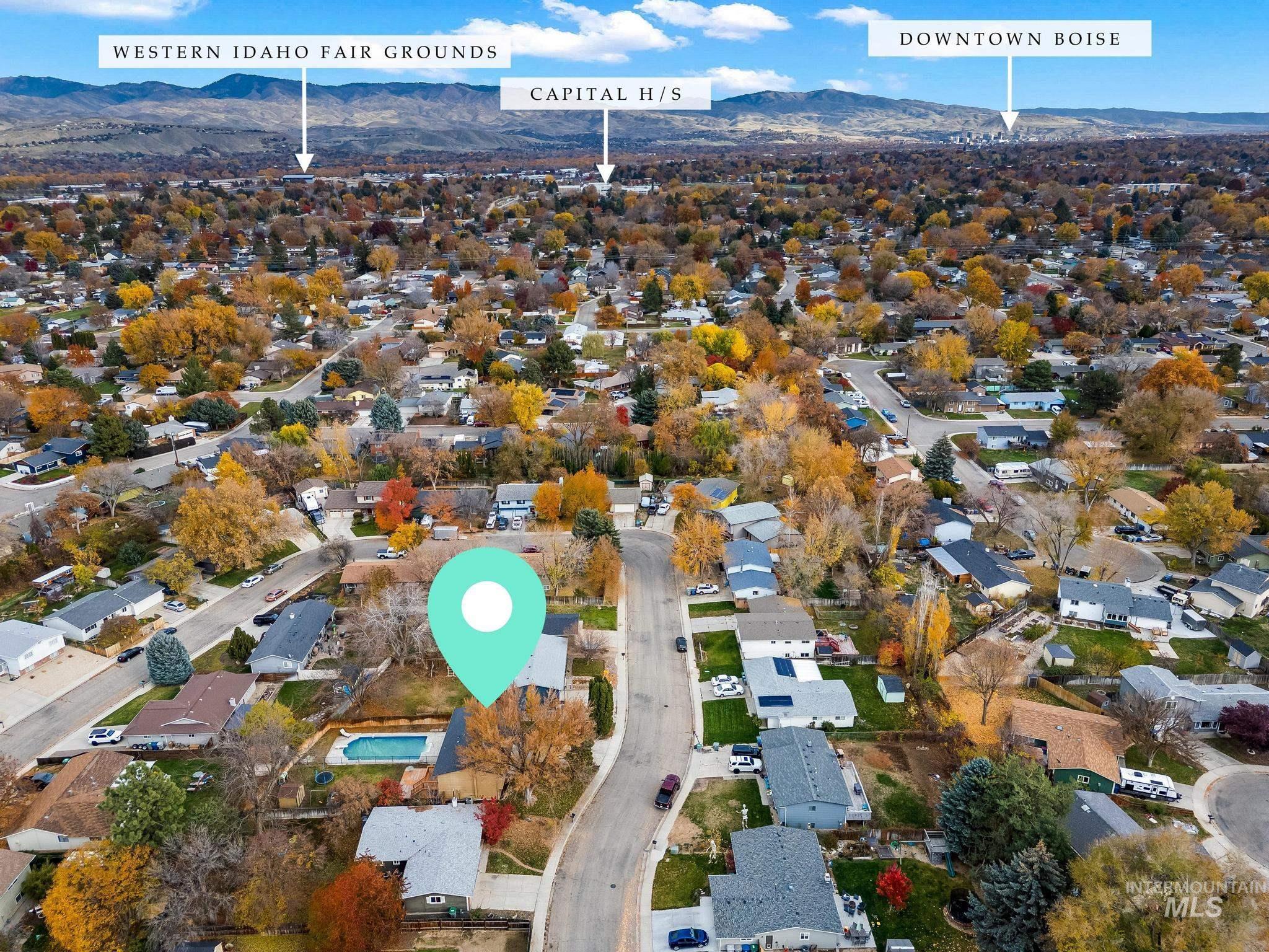 Aerial view of property's location featuring nearby suburban area and mountains