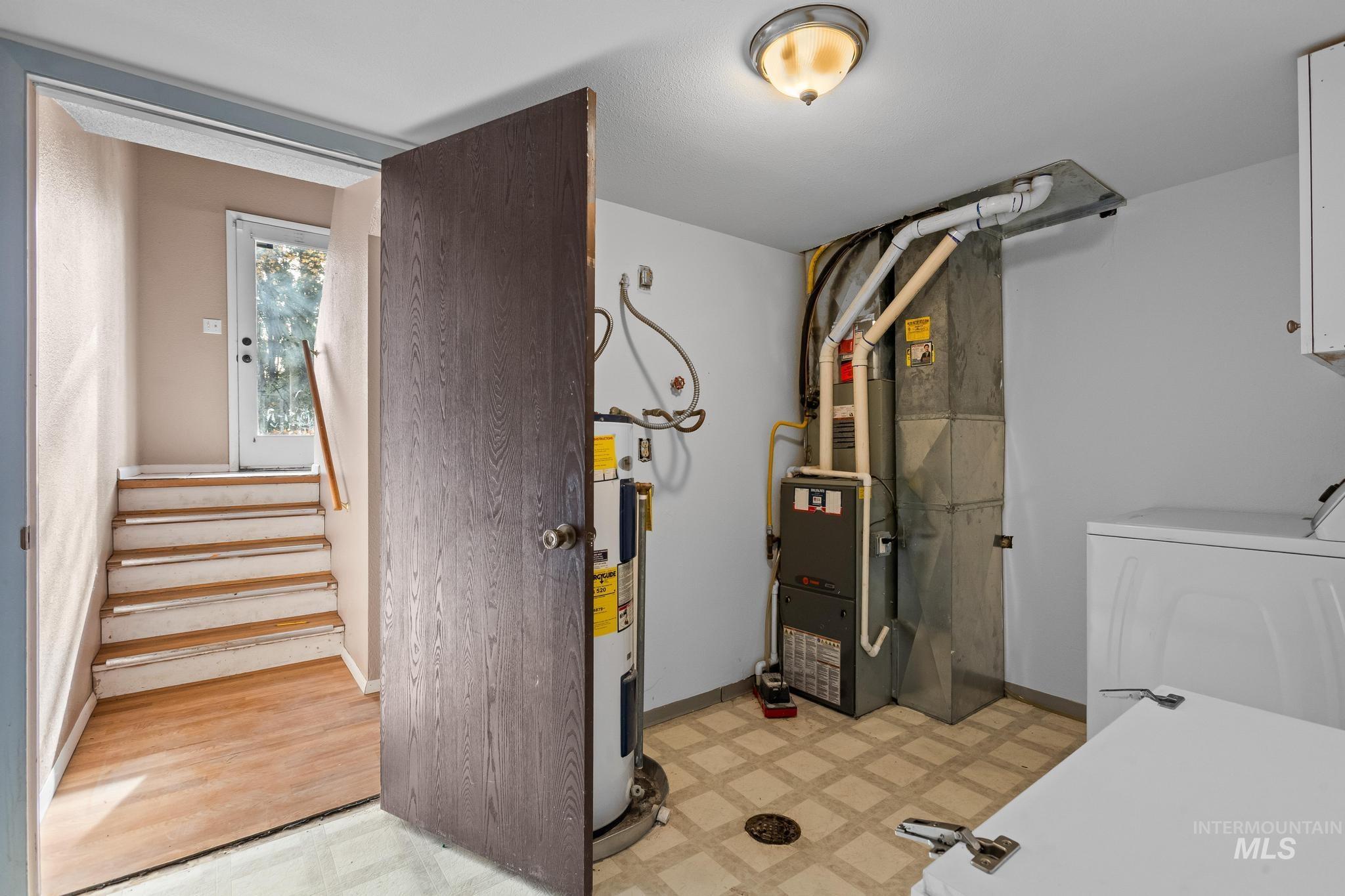 Utility room with heating unit and electric water heater