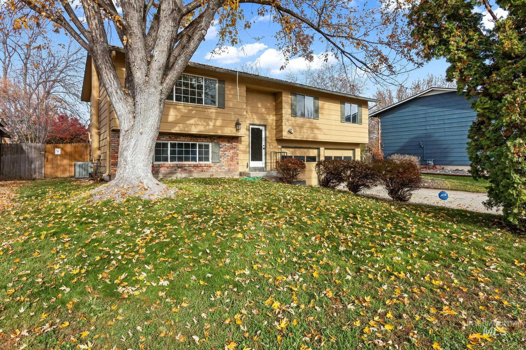 Bi-level home with brick siding and an attached garage