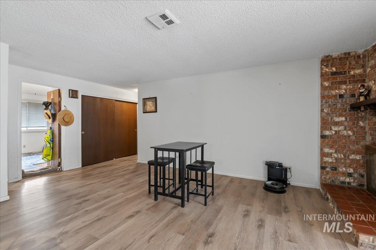 Dining room featuring light wood-style flooring and a textured ceiling