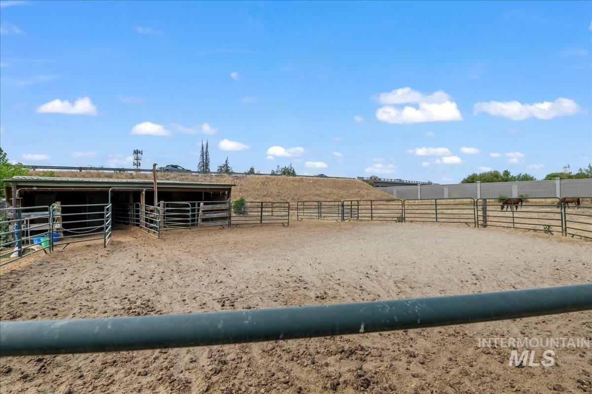 View of yard with an exterior structure, an outdoor structure, and a rural view