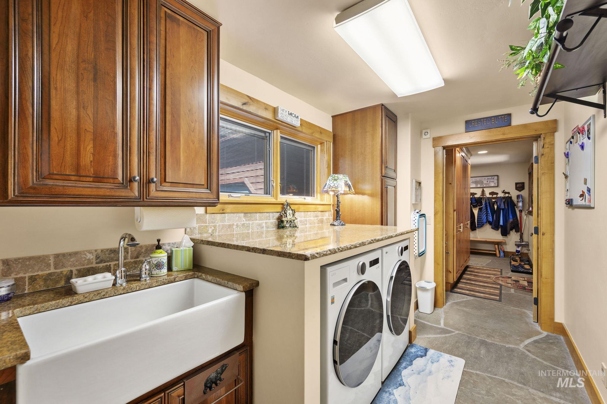 Washroom featuring washing machine and clothes dryer and cabinet space