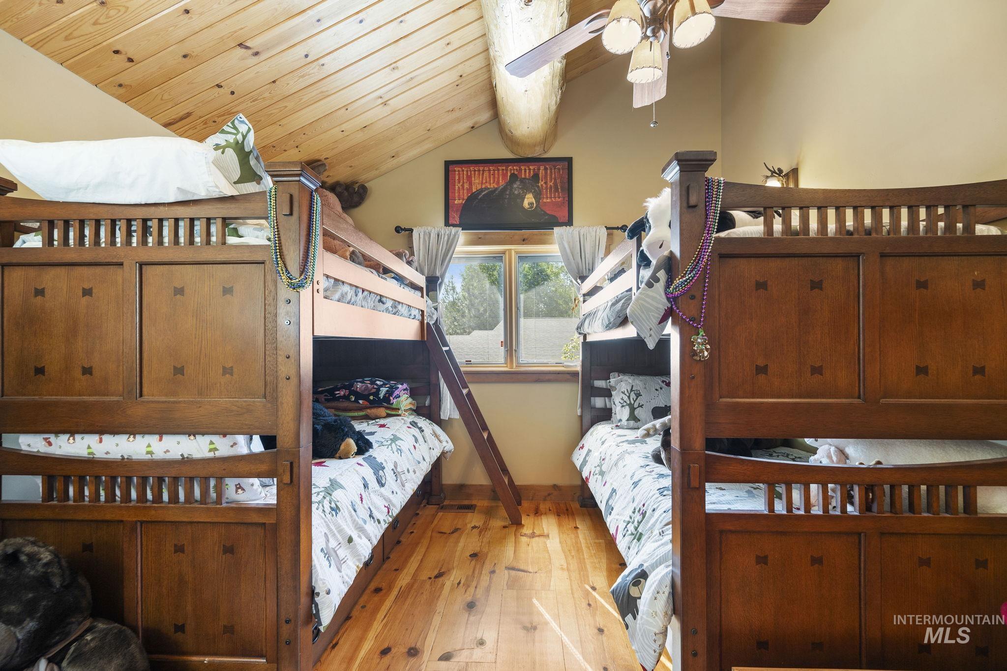 Bedroom with wood-type flooring and wooden ceiling