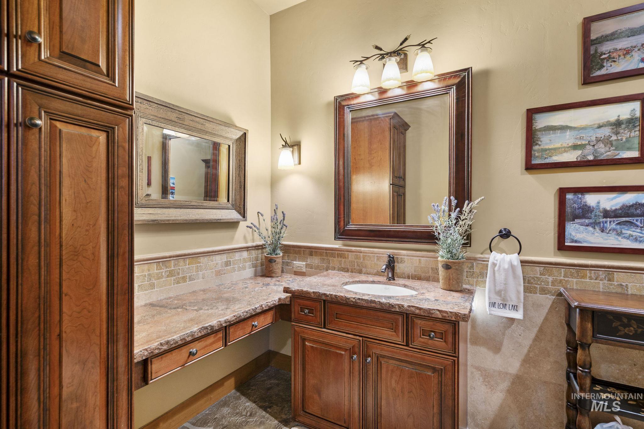Bathroom featuring vanity, tile walls, and wainscoting