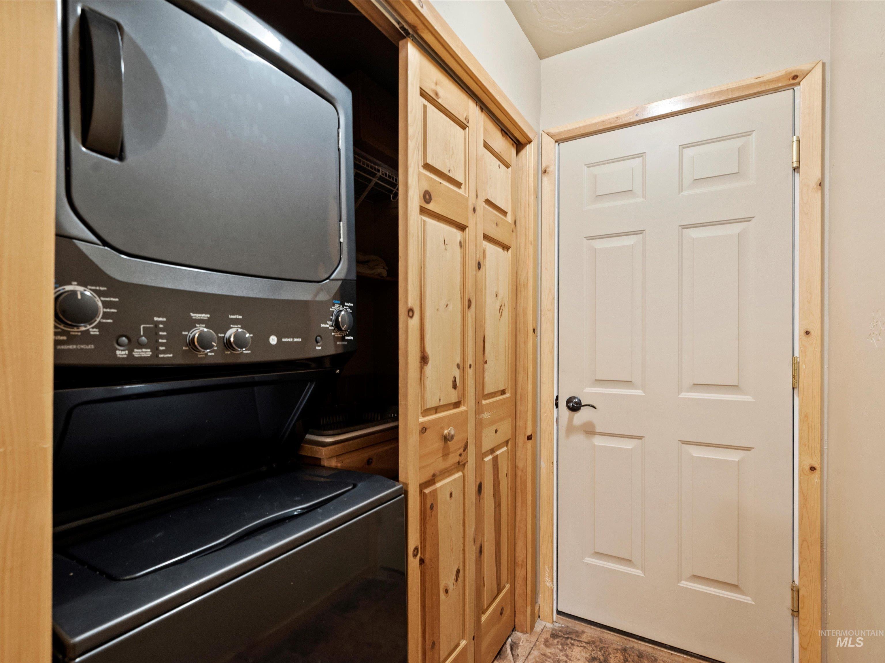 Laundry area featuring stacked washer and dryer