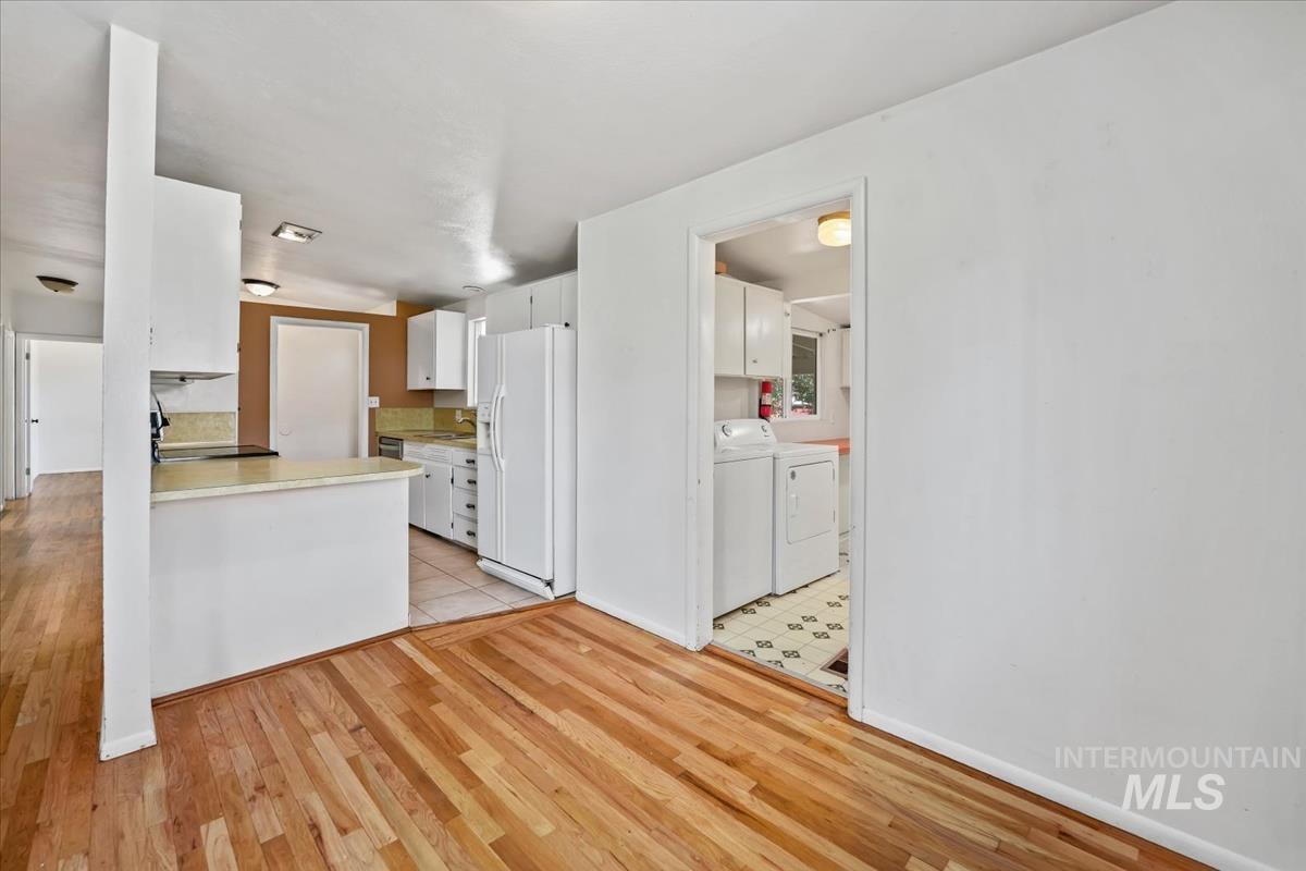 Kitchen with white cabinetry, light-toned countertops, and tile flooring