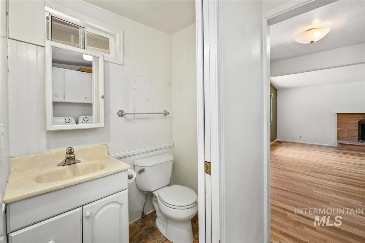 Bathroom featuring a vanity with integrated sink, paneling, and a mirrored medicine cabinet