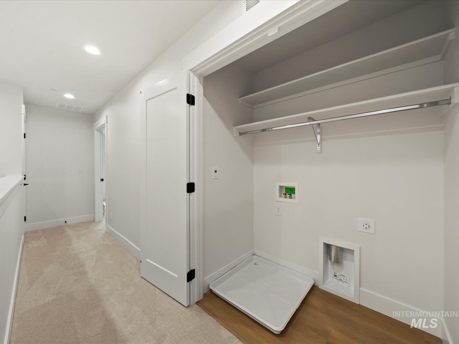 Washroom with recessed lighting, washer hookup, light wood finished floors, and hookup for an electric dryer