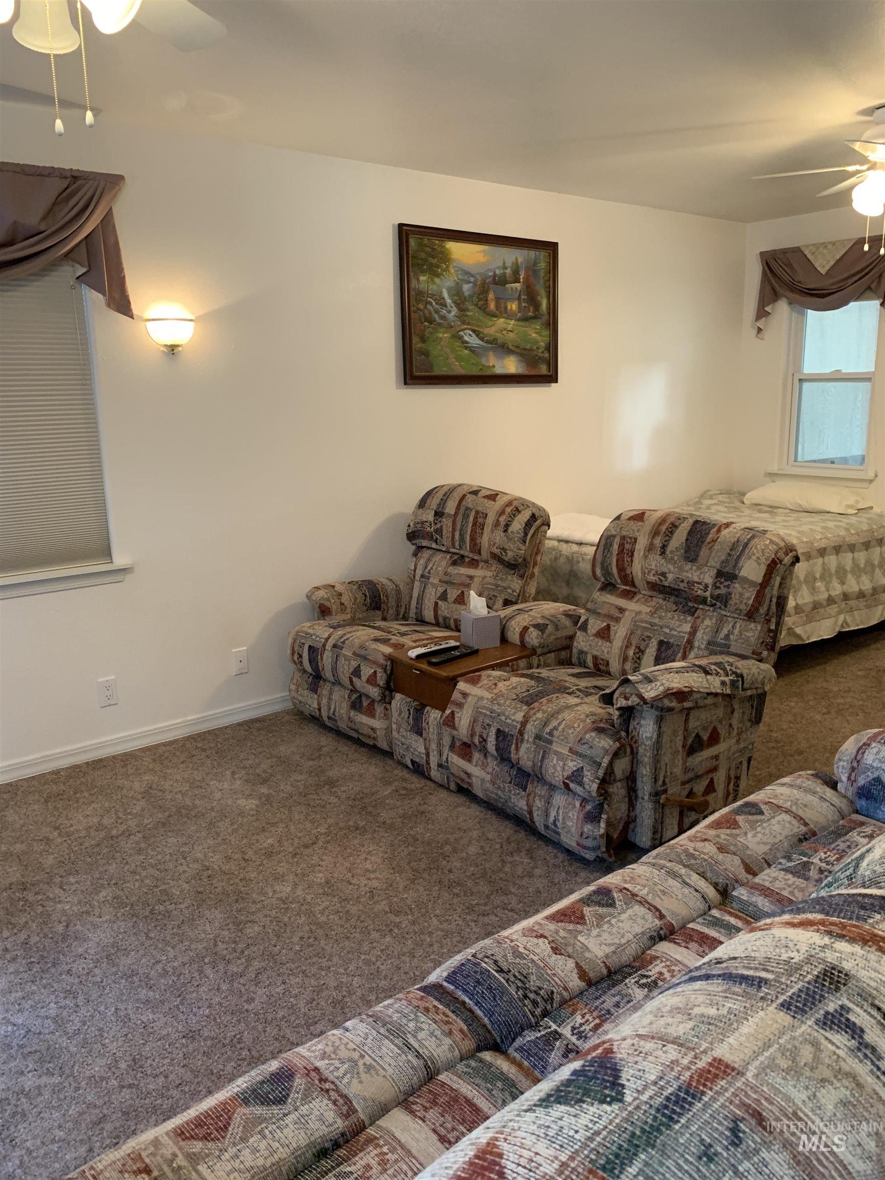 Living room with ceiling fan and carpet floors