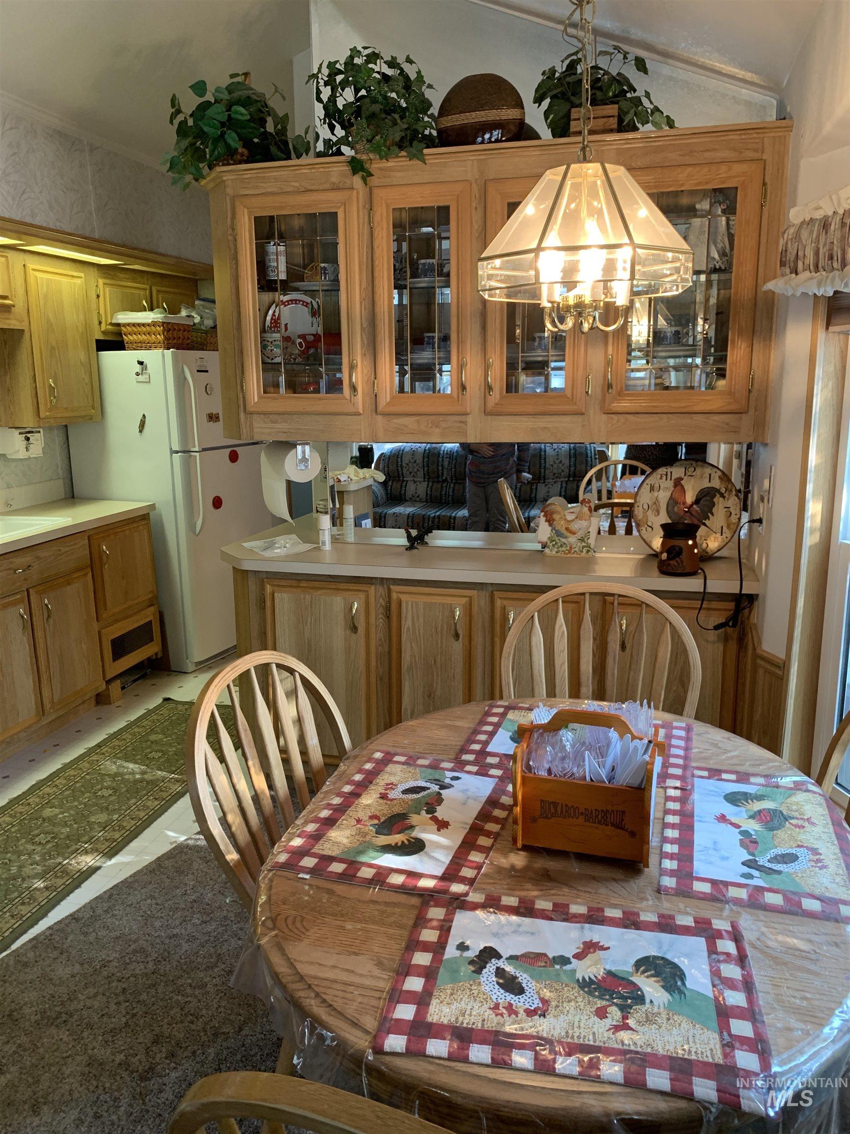 Dining space featuring a chandelier and vaulted ceiling