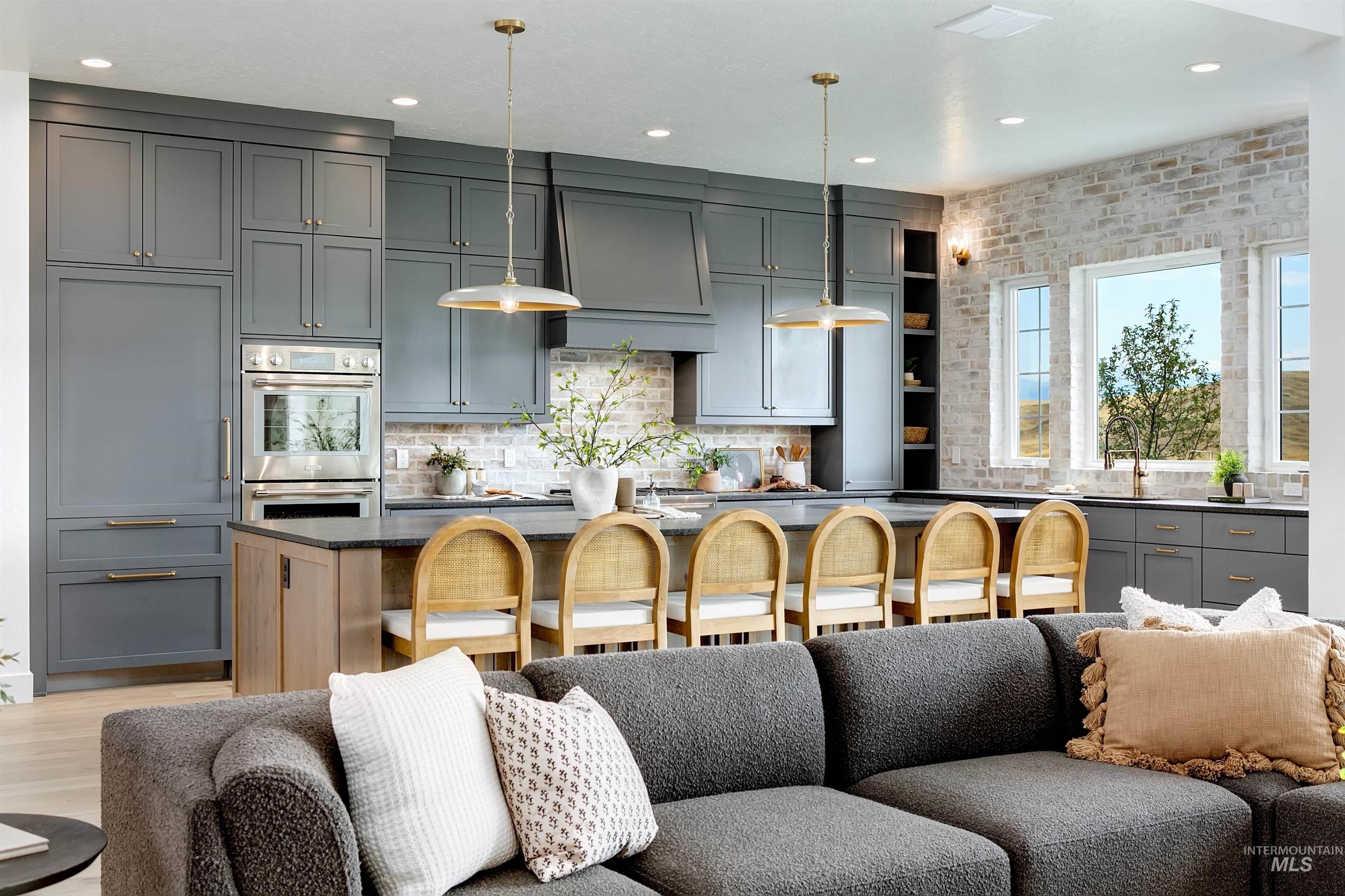 Kitchen featuring open floor plan, gray cabinetry, recessed lighting, open shelves, and decorative backsplash