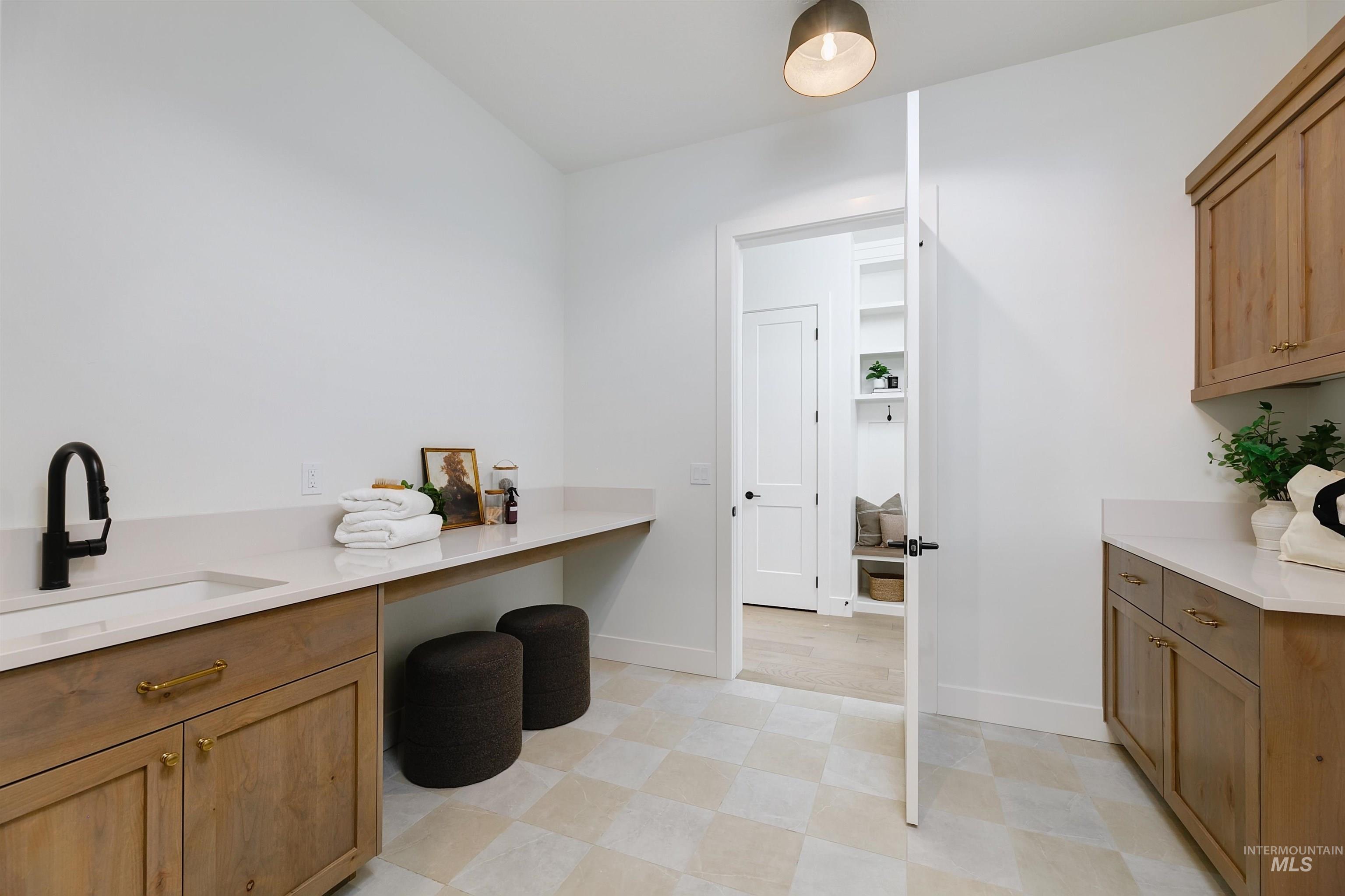 Laundry room with baseboards and cabinet space