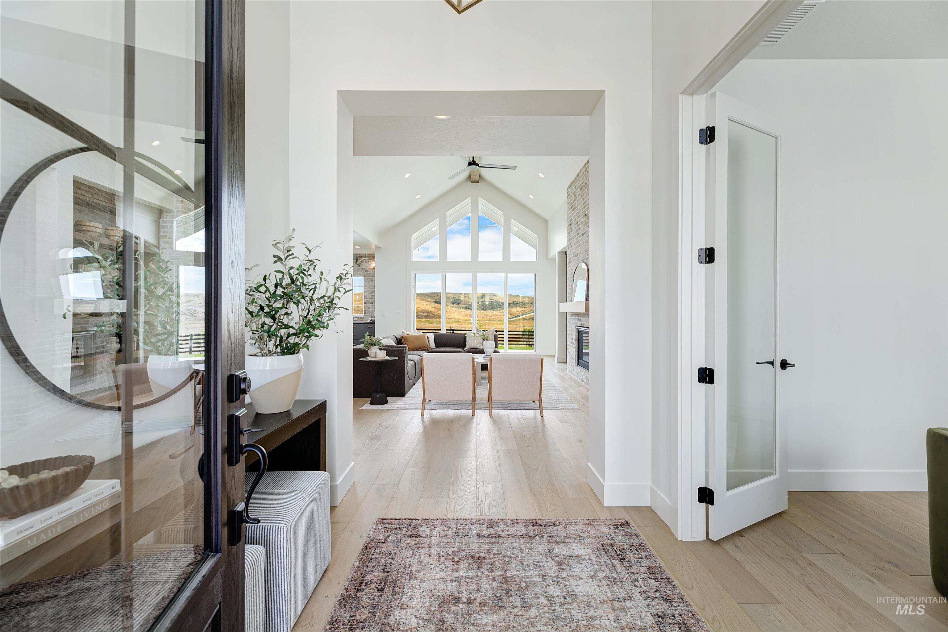 Hall with light wood-style floors, french doors, high vaulted ceiling, and recessed lighting