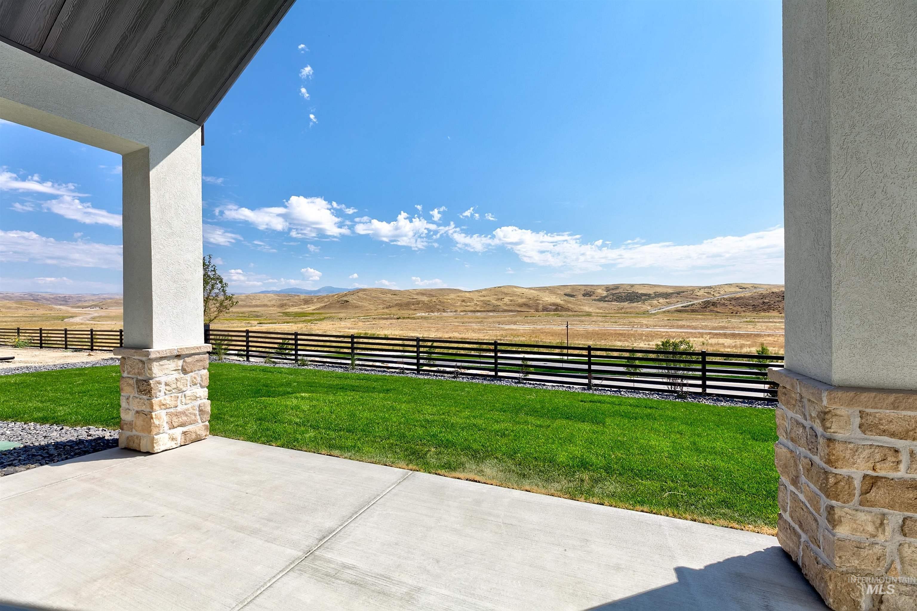 View of yard with a patio area, a mountain view, and a rural view