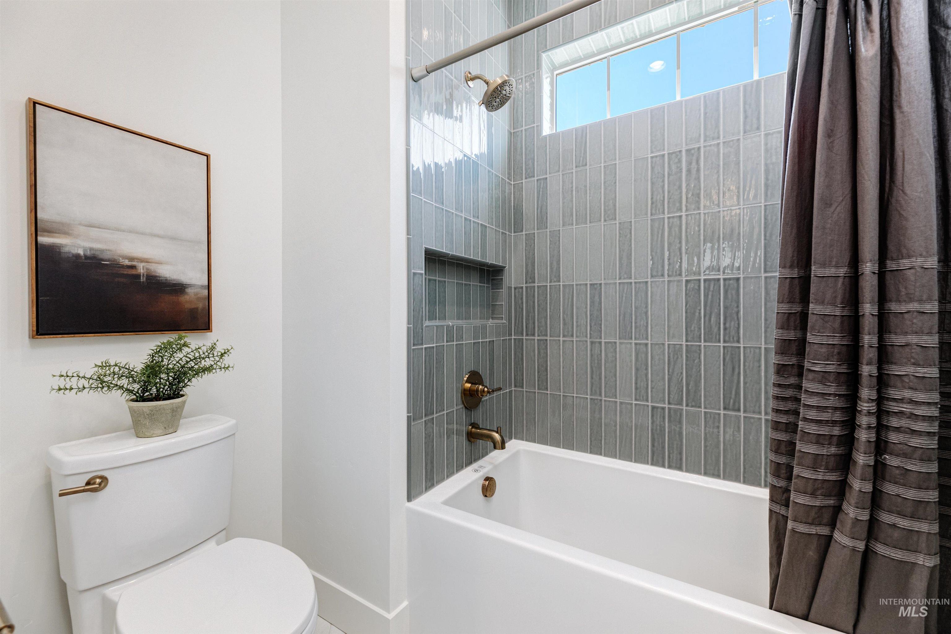 Bathroom with shower / tub combo with curtain and toilet