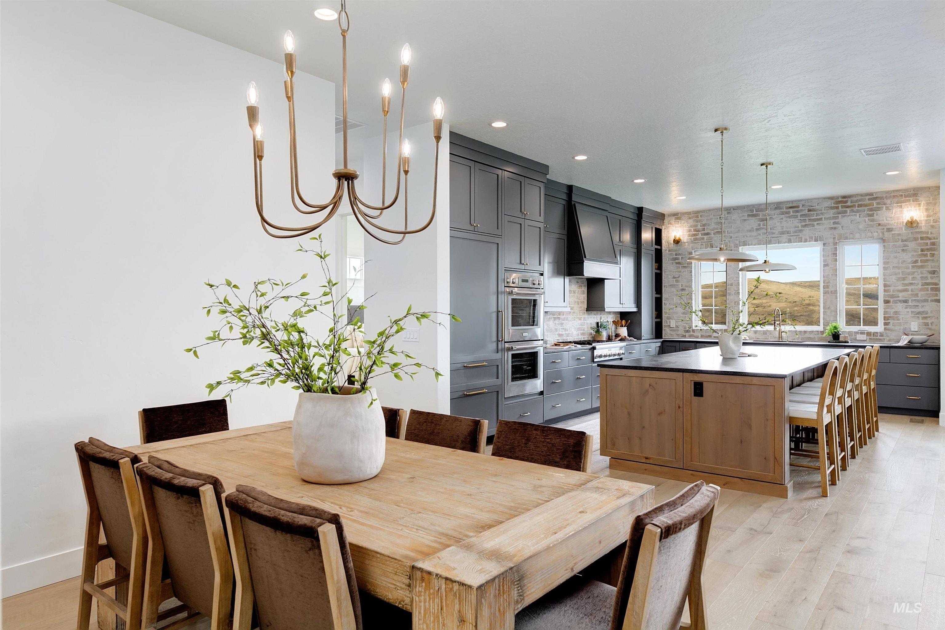 Dining area featuring a chandelier, light wood finished floors, and recessed lighting