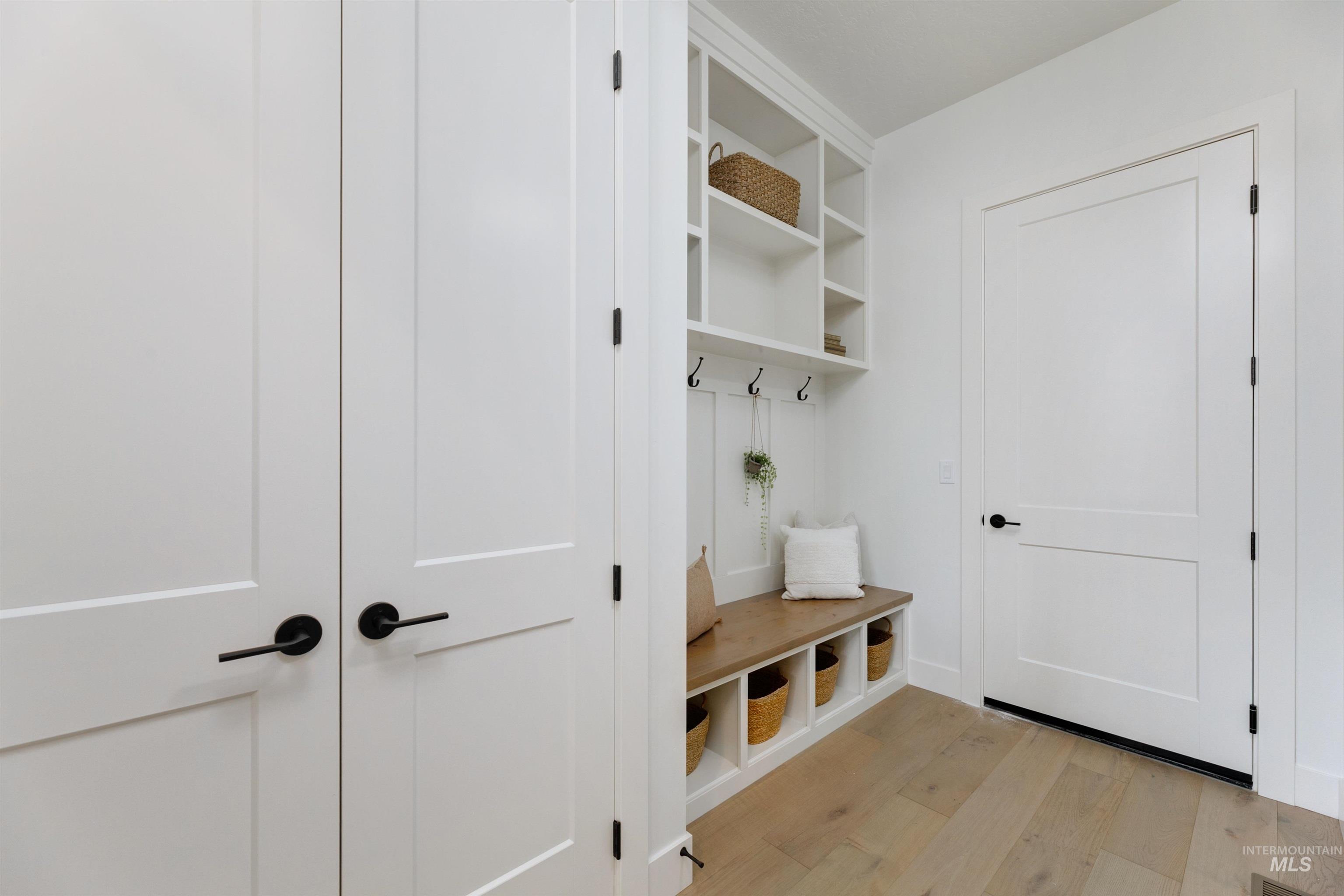 Mudroom featuring light wood finished floors