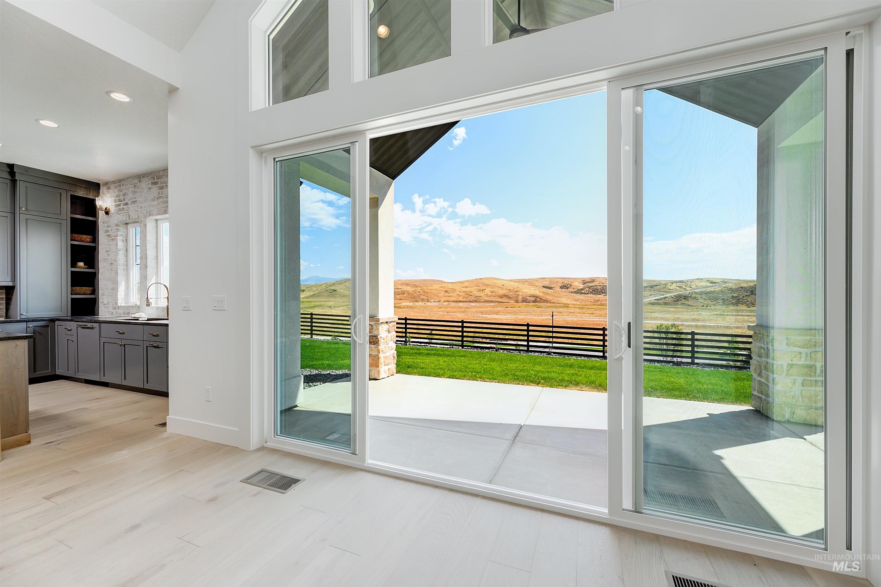 Family room with a mountain view, wood finished floors, recessed lighting, and a view of countryside