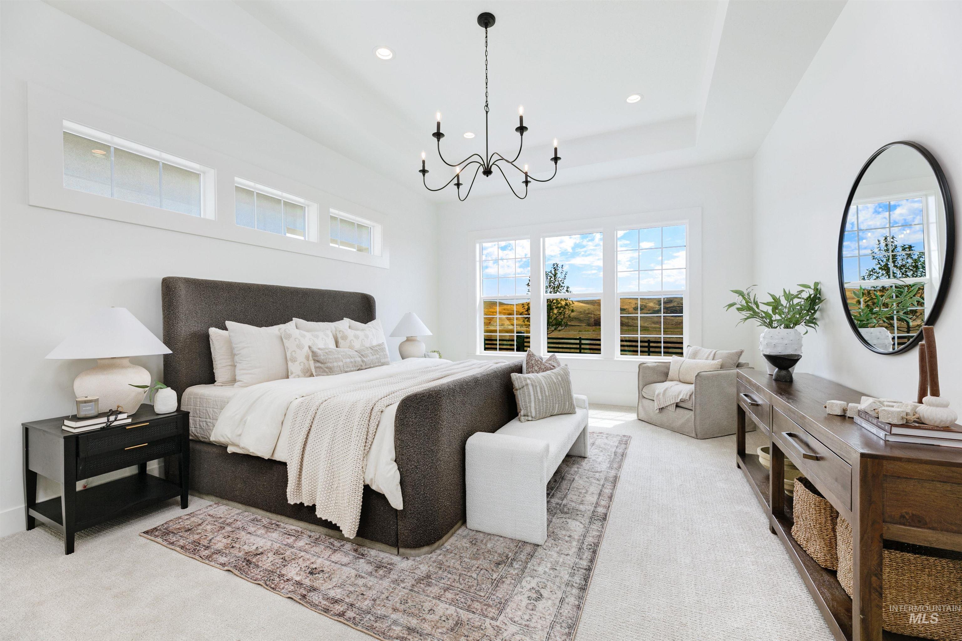 Bedroom with light carpet, a chandelier, recessed lighting, and a tray ceiling