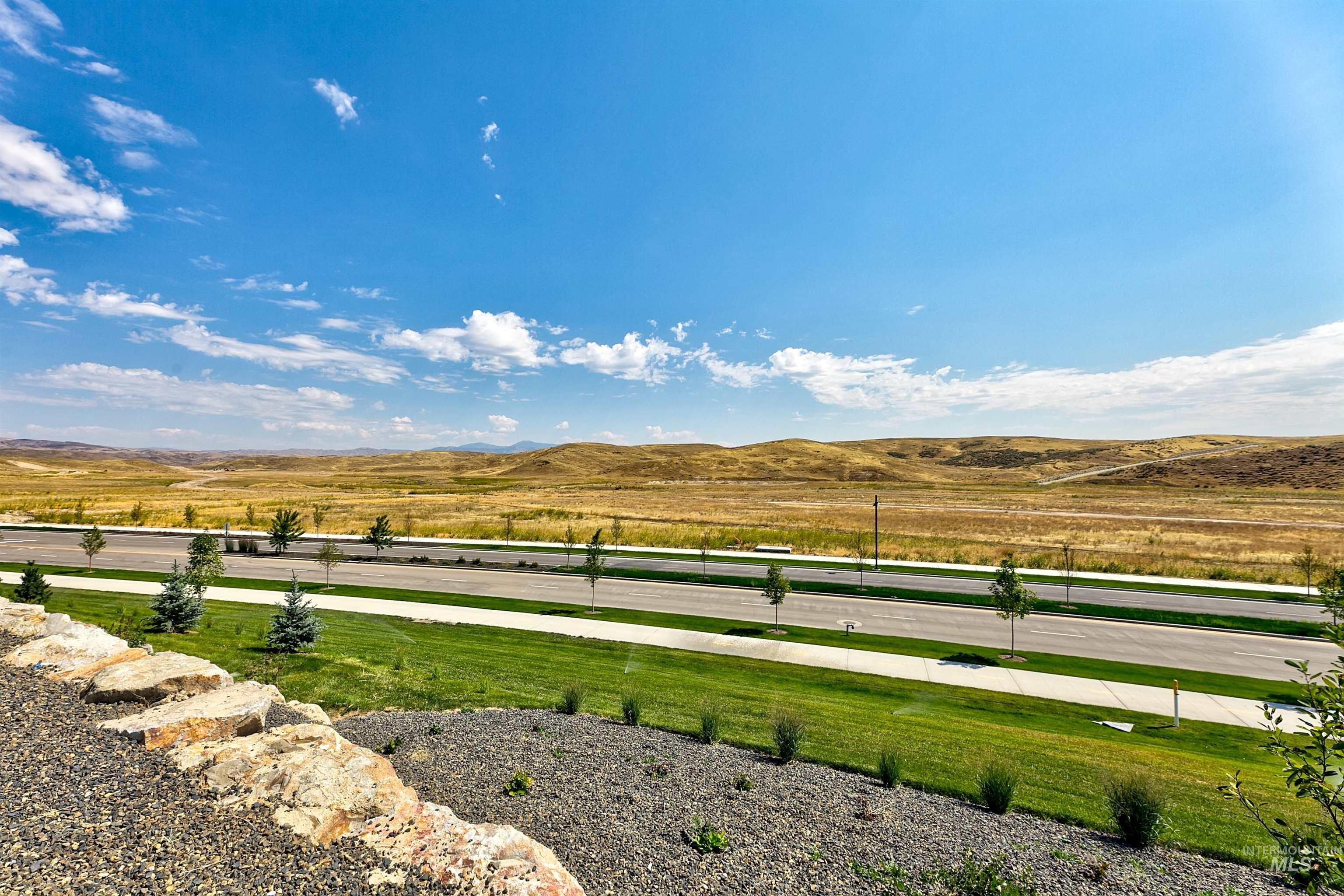 View of green lawn featuring a mountain view