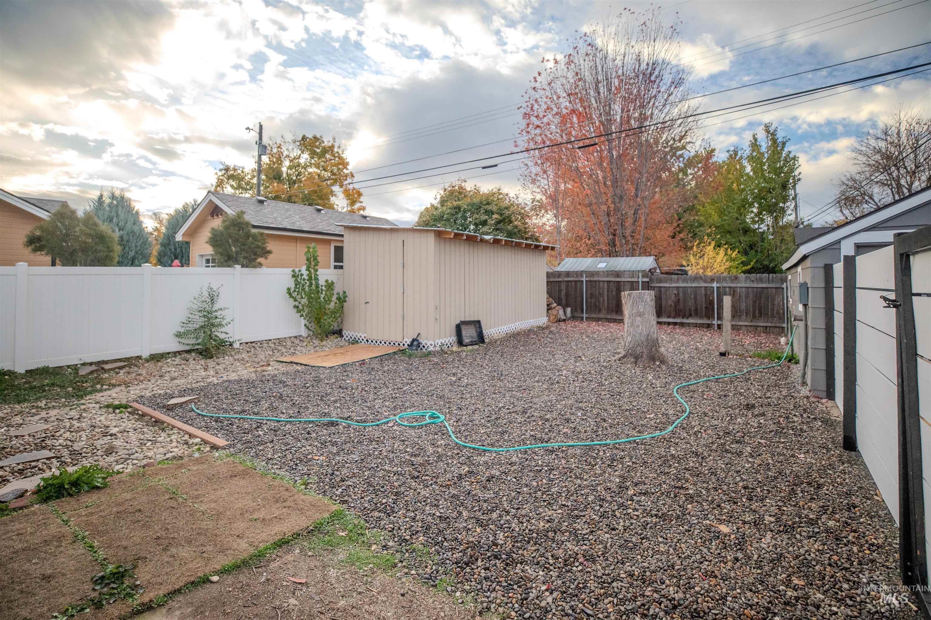 Fenced backyard with storage shed