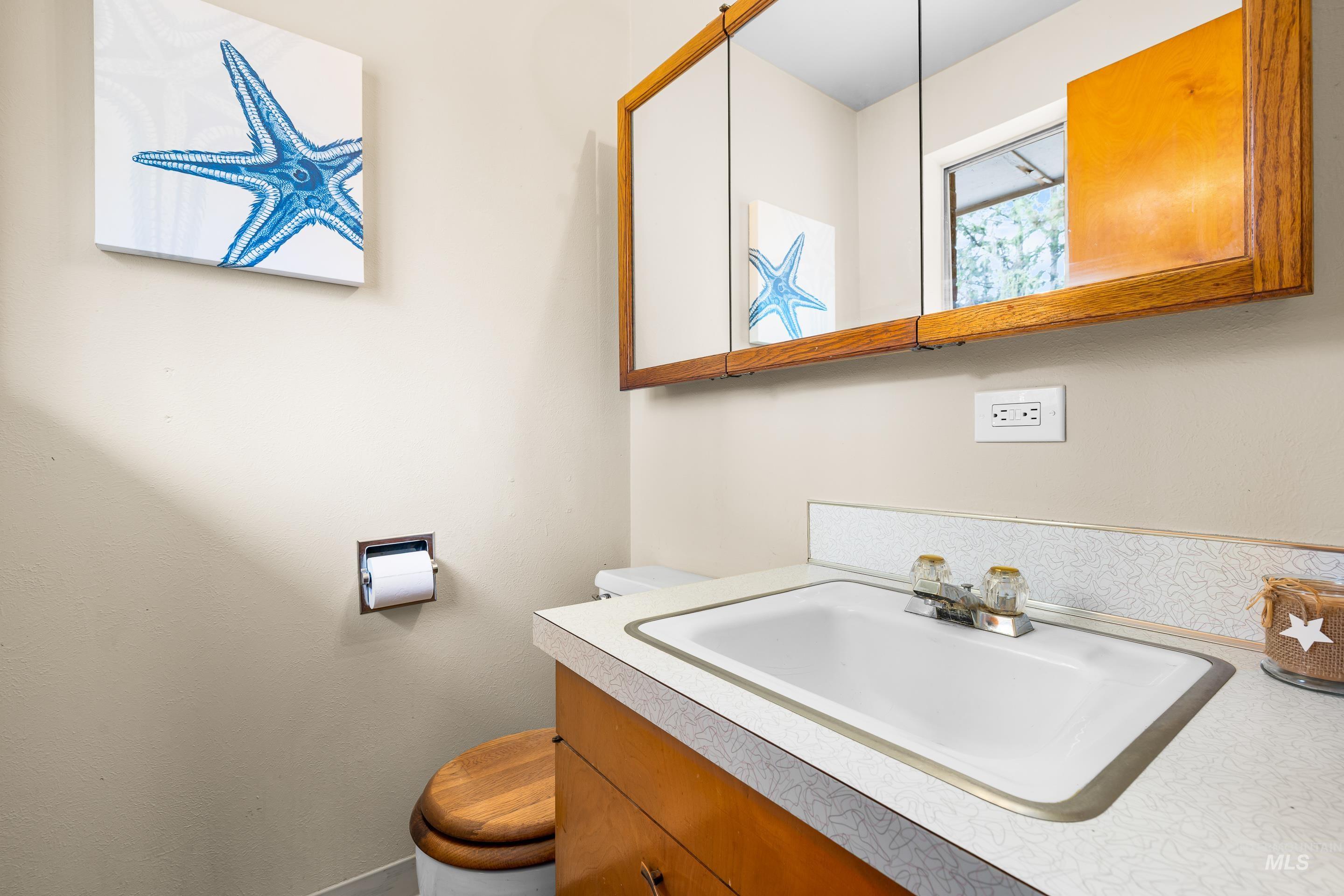 Half bathroom featuring toilet and vanity