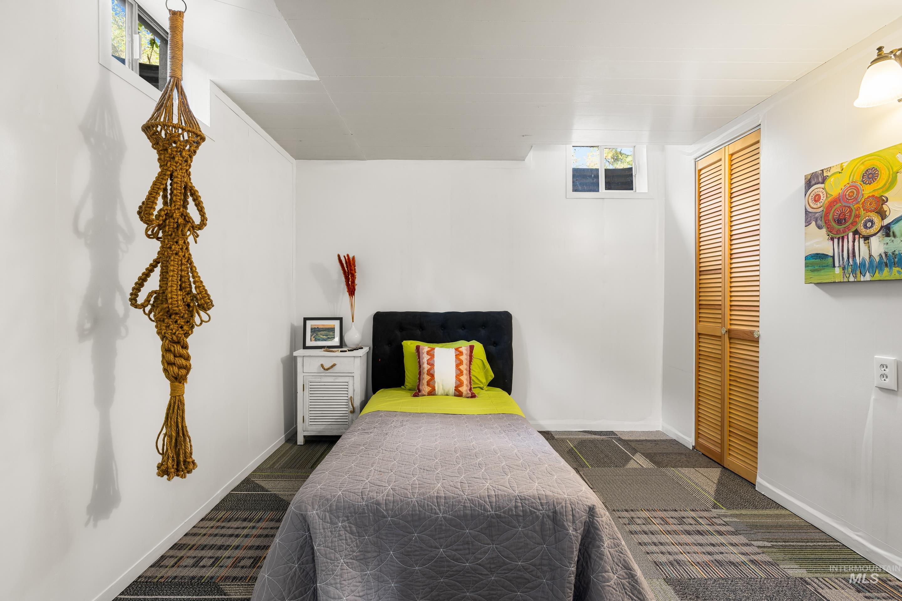 Bedroom featuring dark carpet and a closet