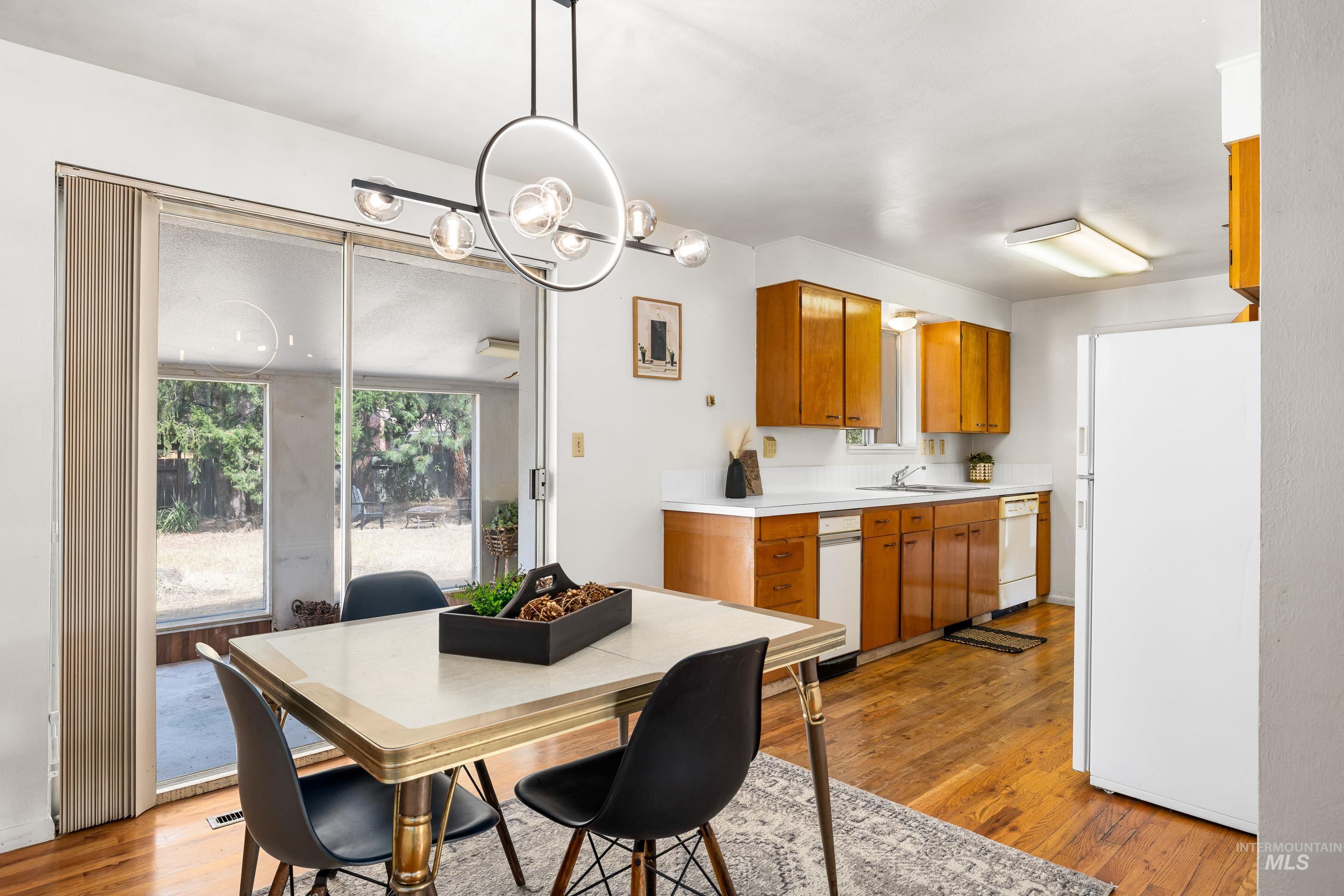 Dining area with light wood finished floors and a chandelier