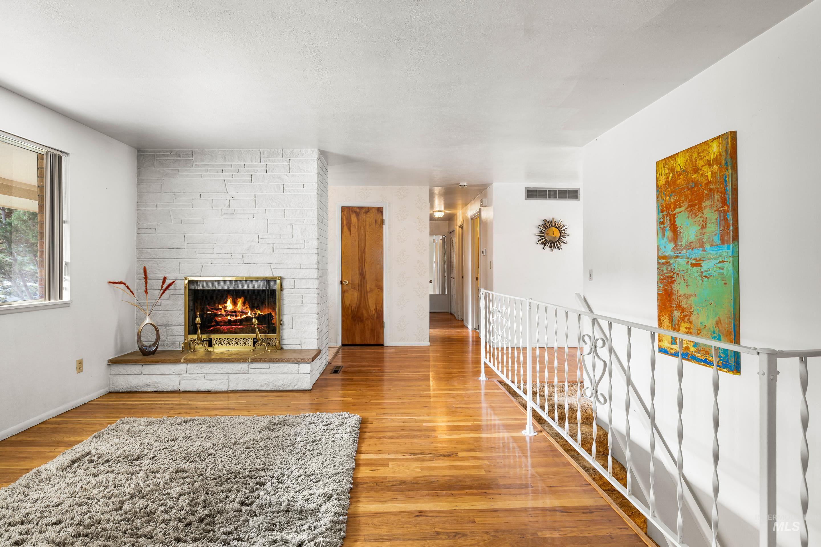 Living area with a fireplace and wood finished floors