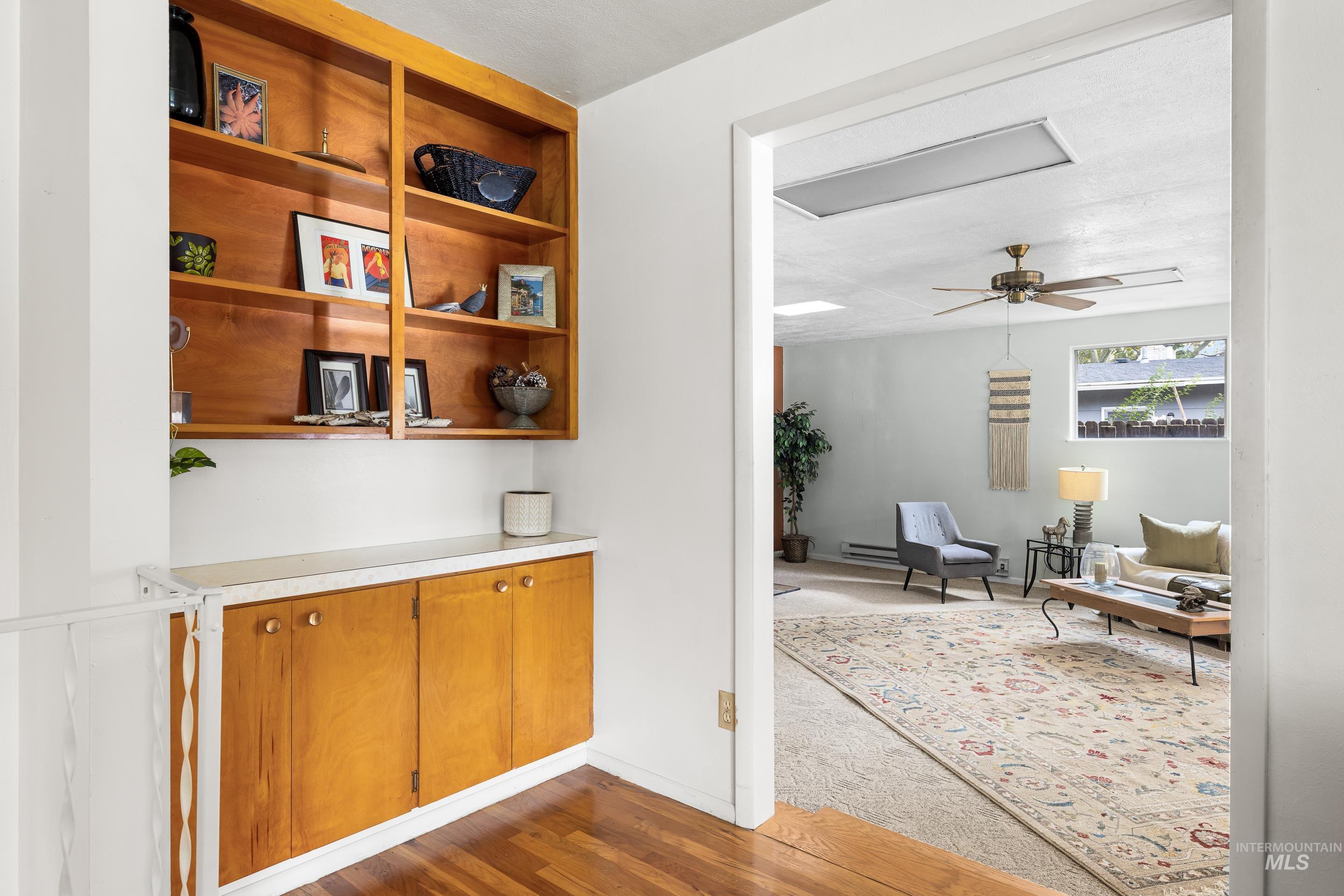 Hallway with dark wood-style flooring and baseboards