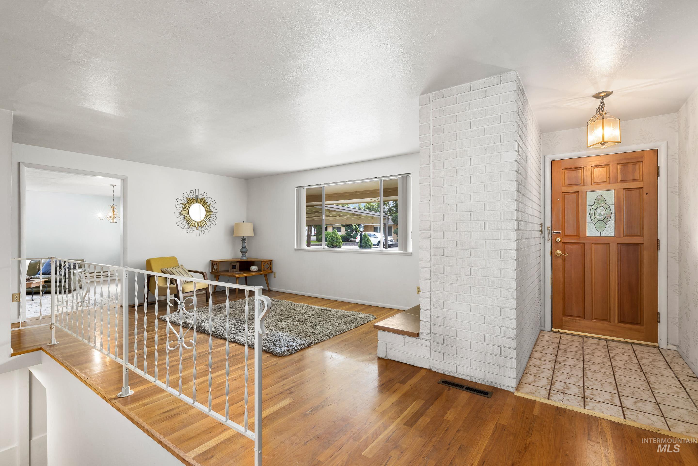 Entryway featuring light wood-style flooring and a chandelier