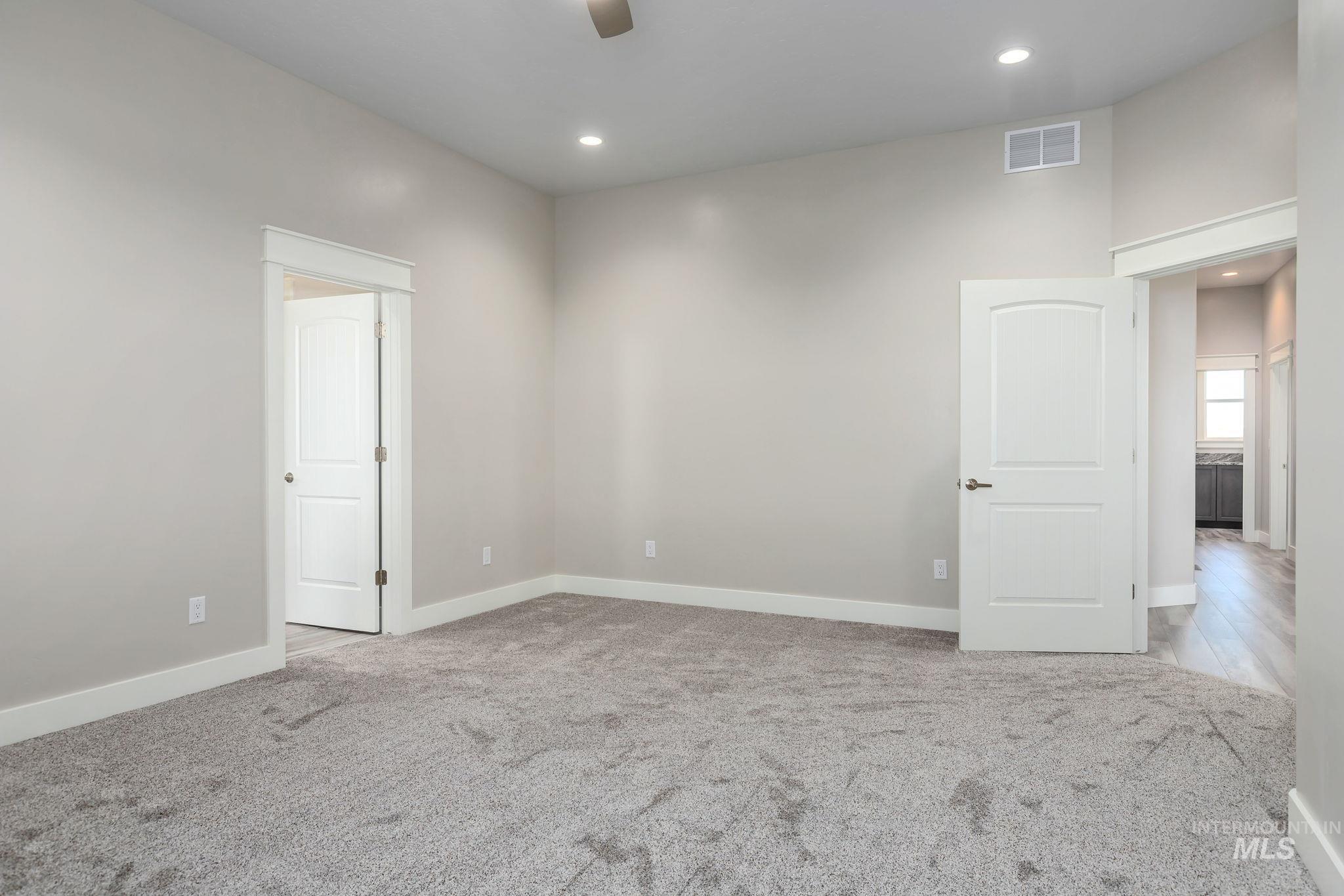 Spare room featuring carpet flooring, a ceiling fan, and recessed lighting