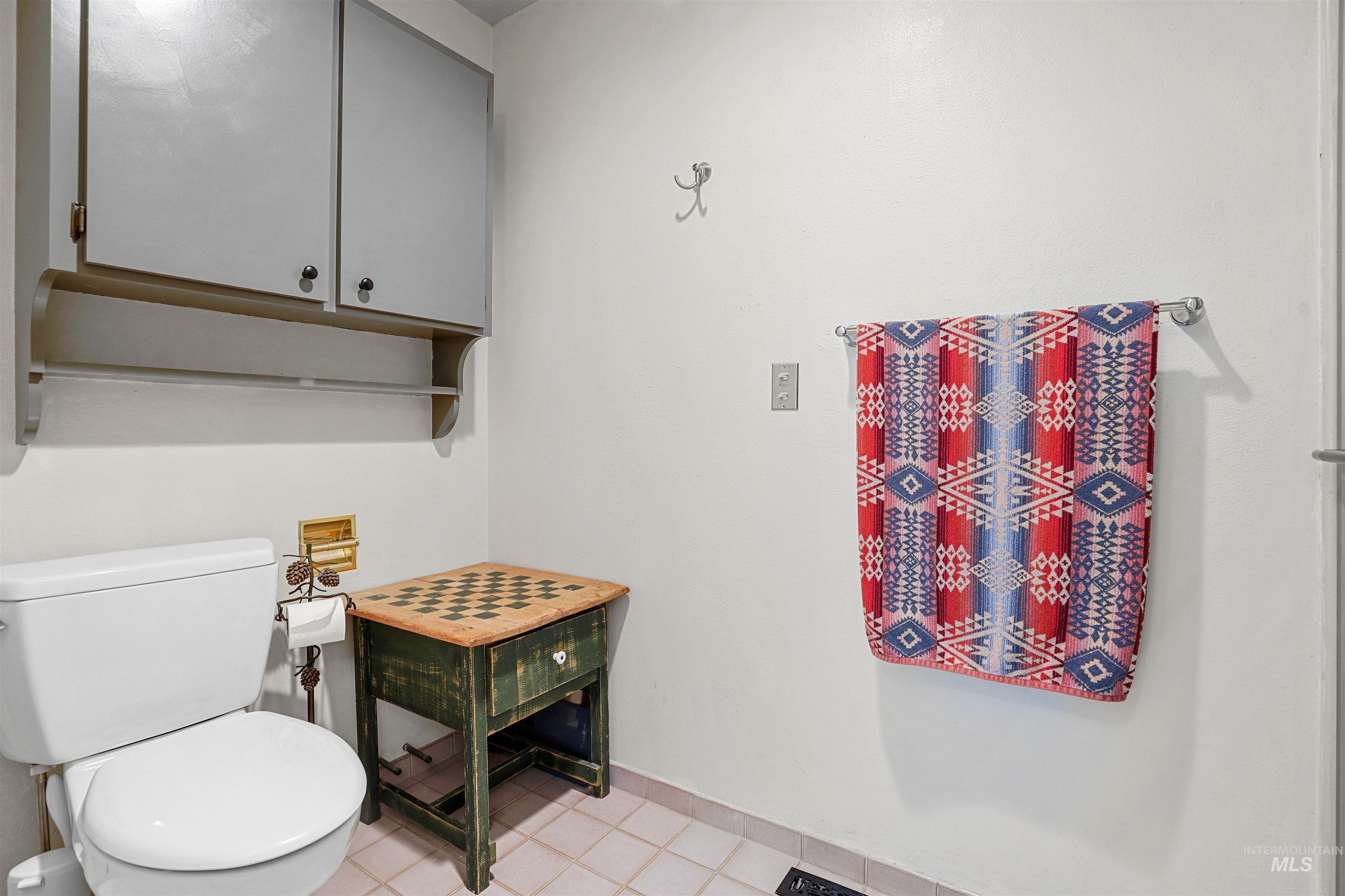 Bathroom featuring toilet and tile patterned flooring