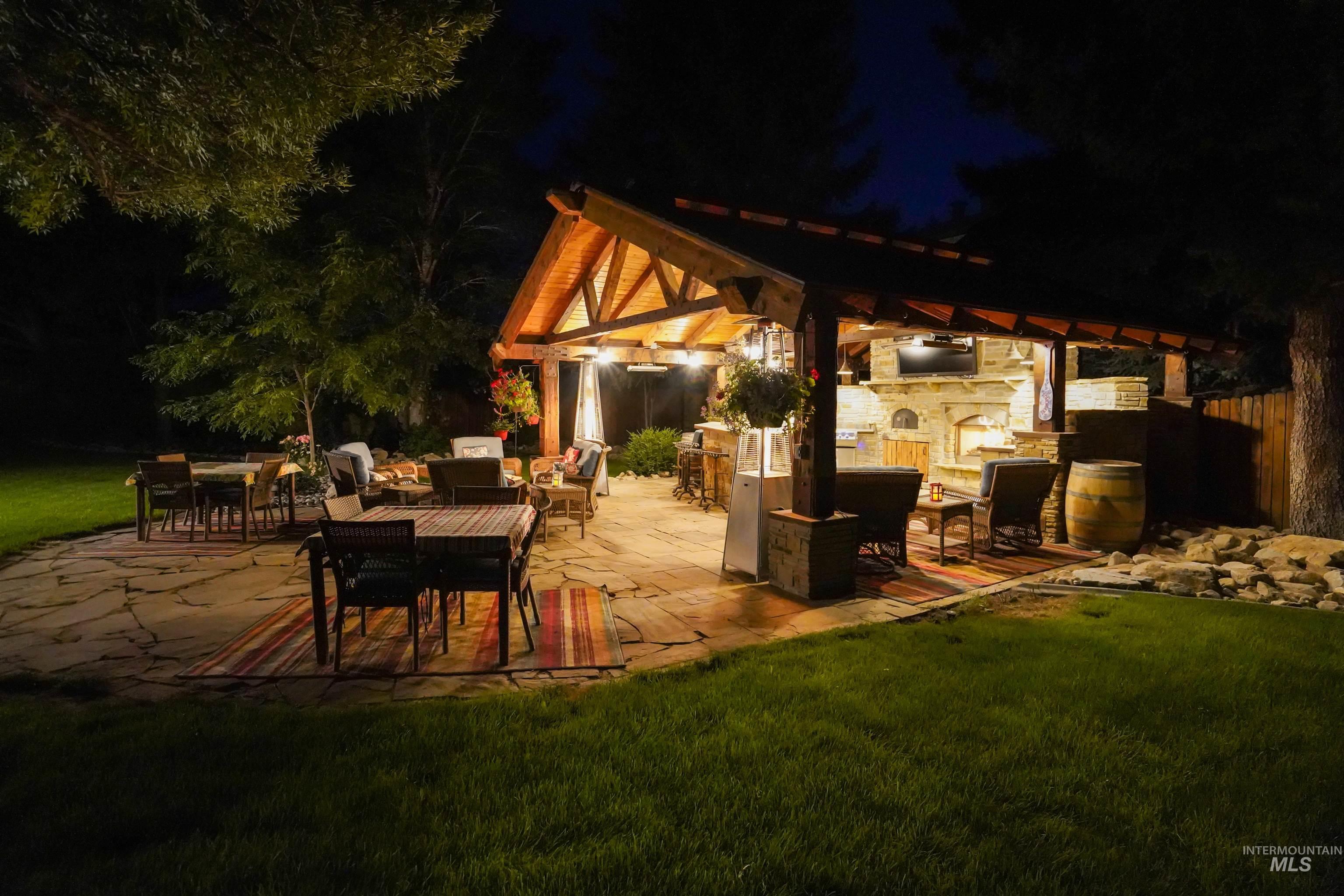 View of patio with an outdoor living space with a fireplace and outdoor dining area