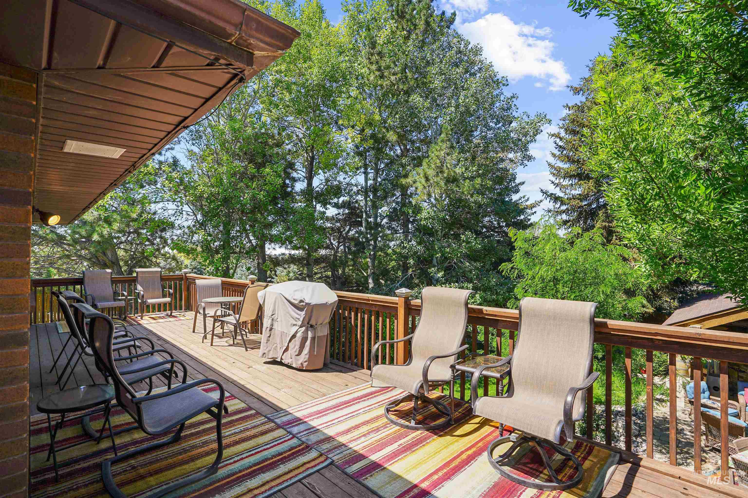 Wooden deck featuring area for grilling