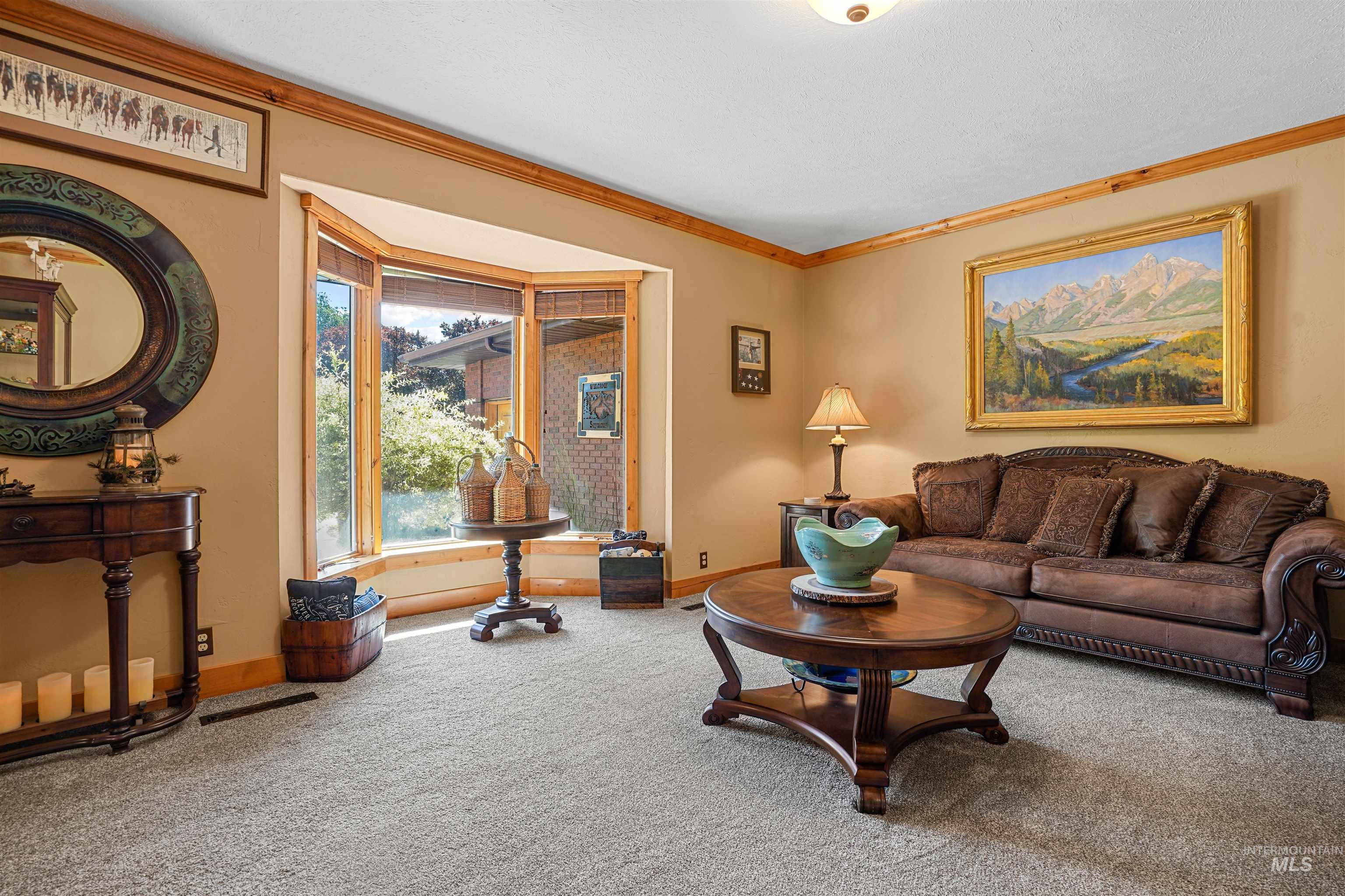 Living room featuring carpet and ornamental molding