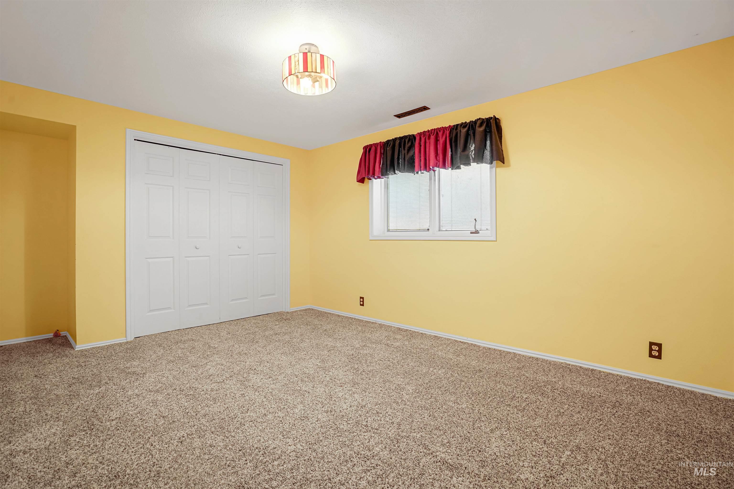 Unfurnished bedroom with carpet and a closet