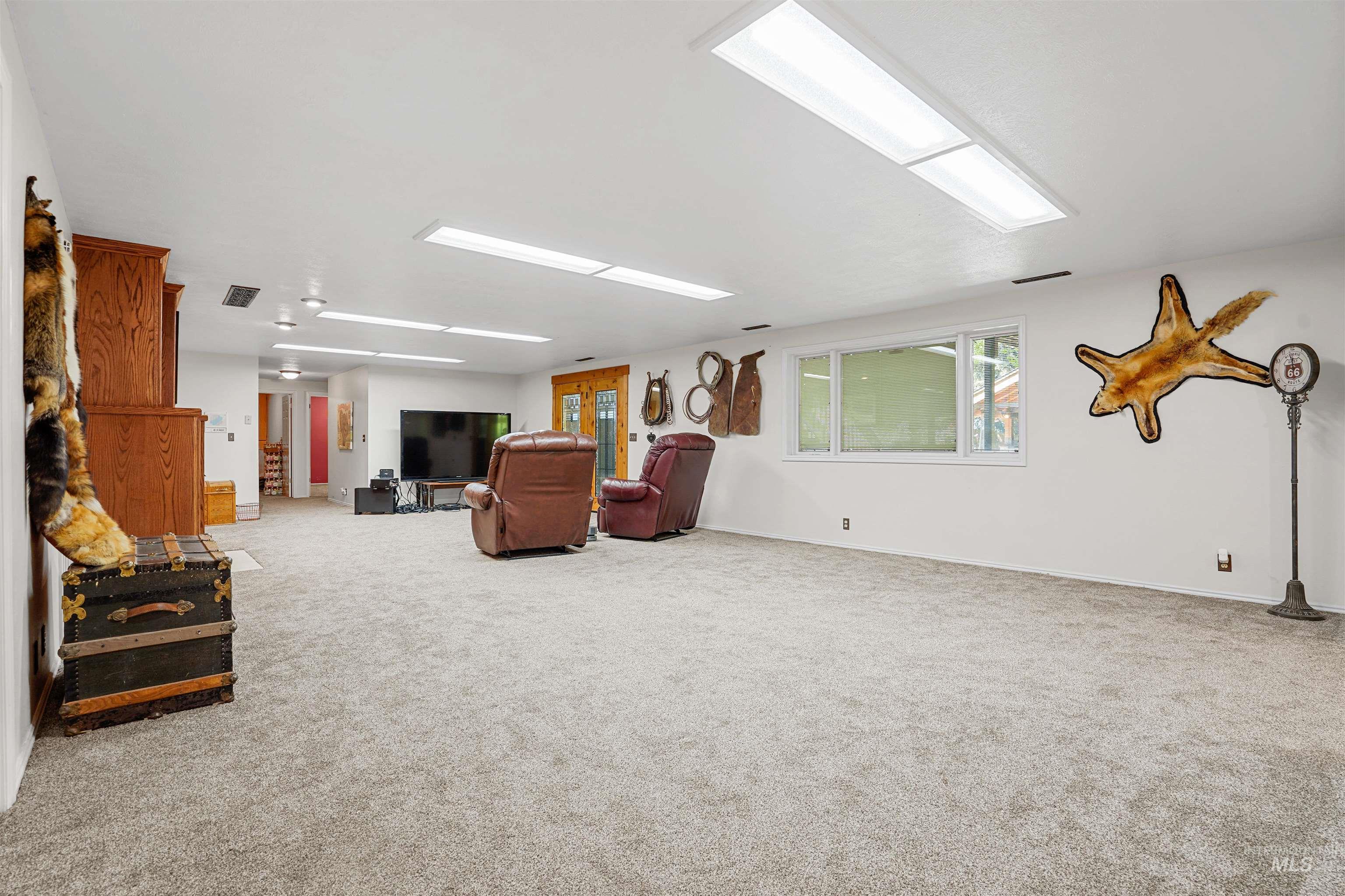 Living room featuring carpet floors and plenty of natural light