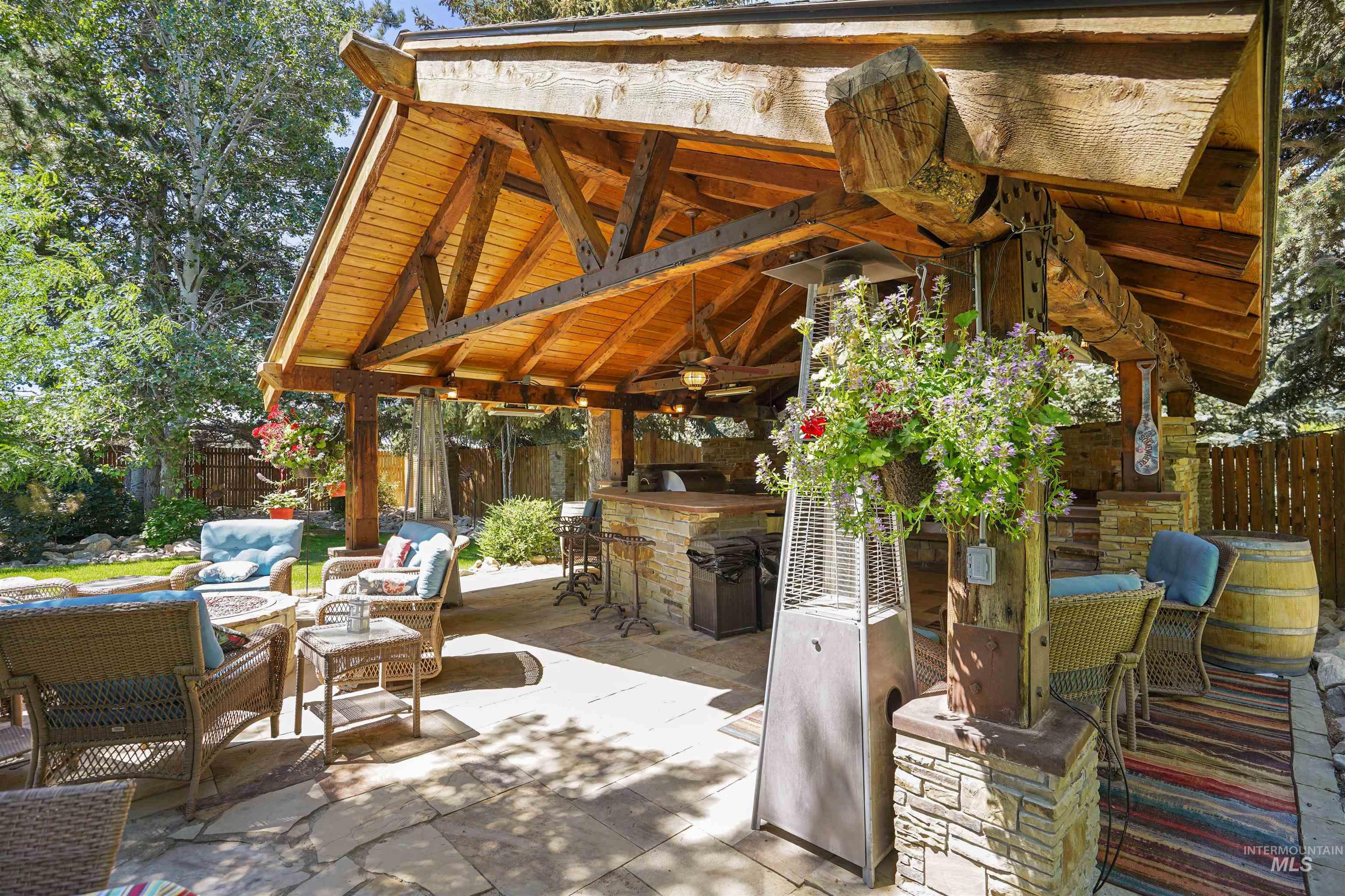 Fenced backyard with a gazebo, an outdoor living space, a ceiling fan, and a patio
