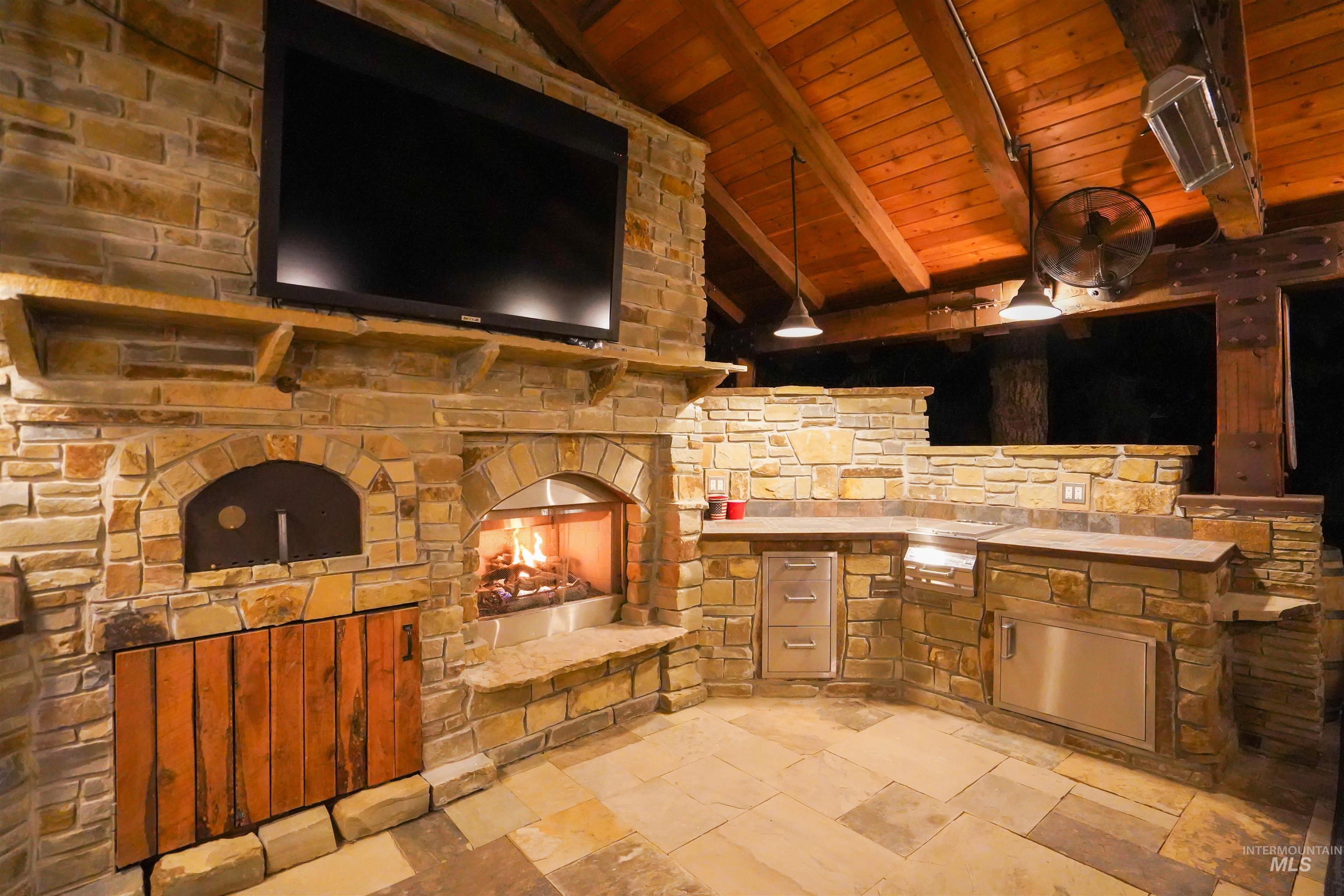View of patio / terrace with a stone fireplace