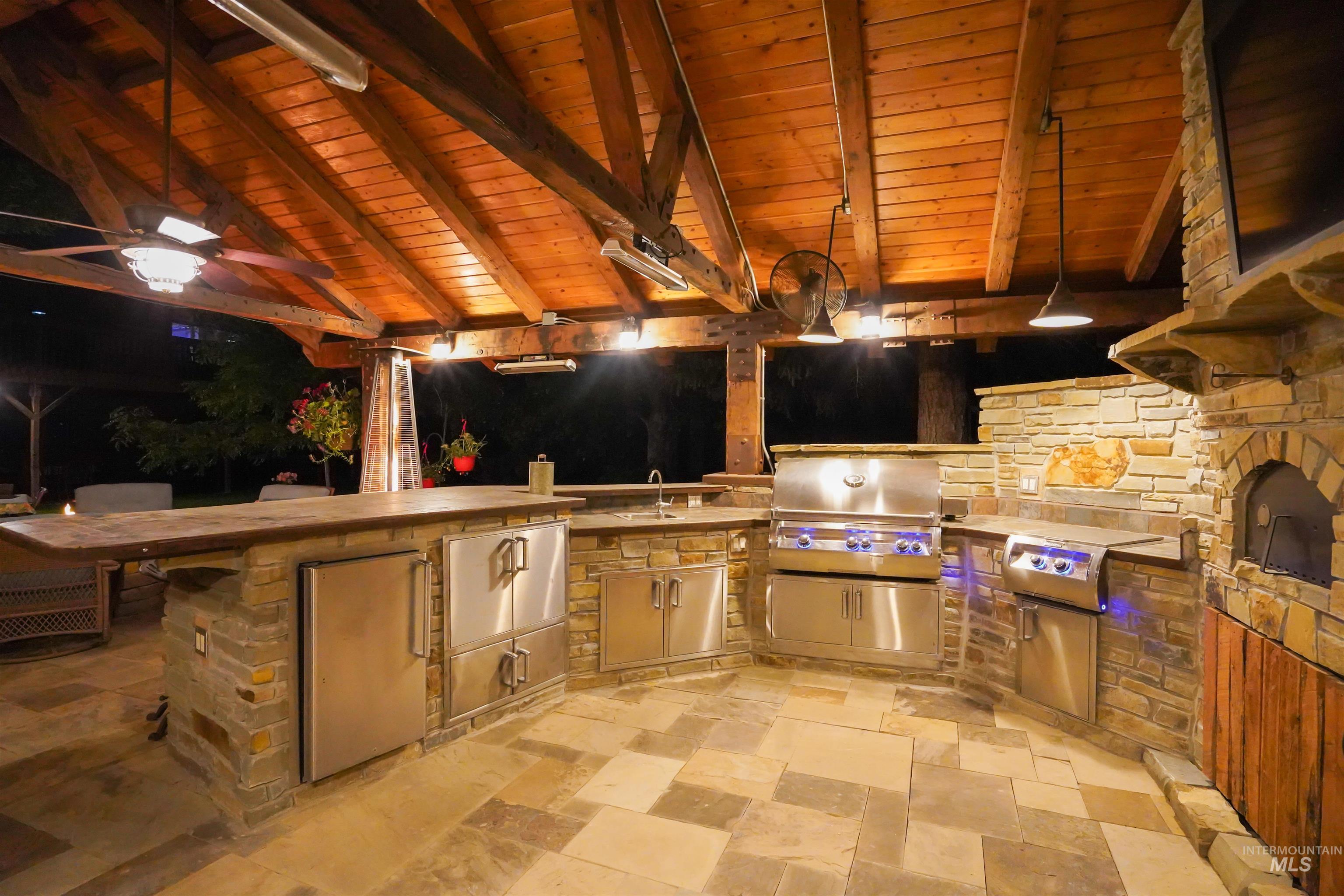 View of patio / terrace featuring a ceiling fan, area for grilling, and a gazebo