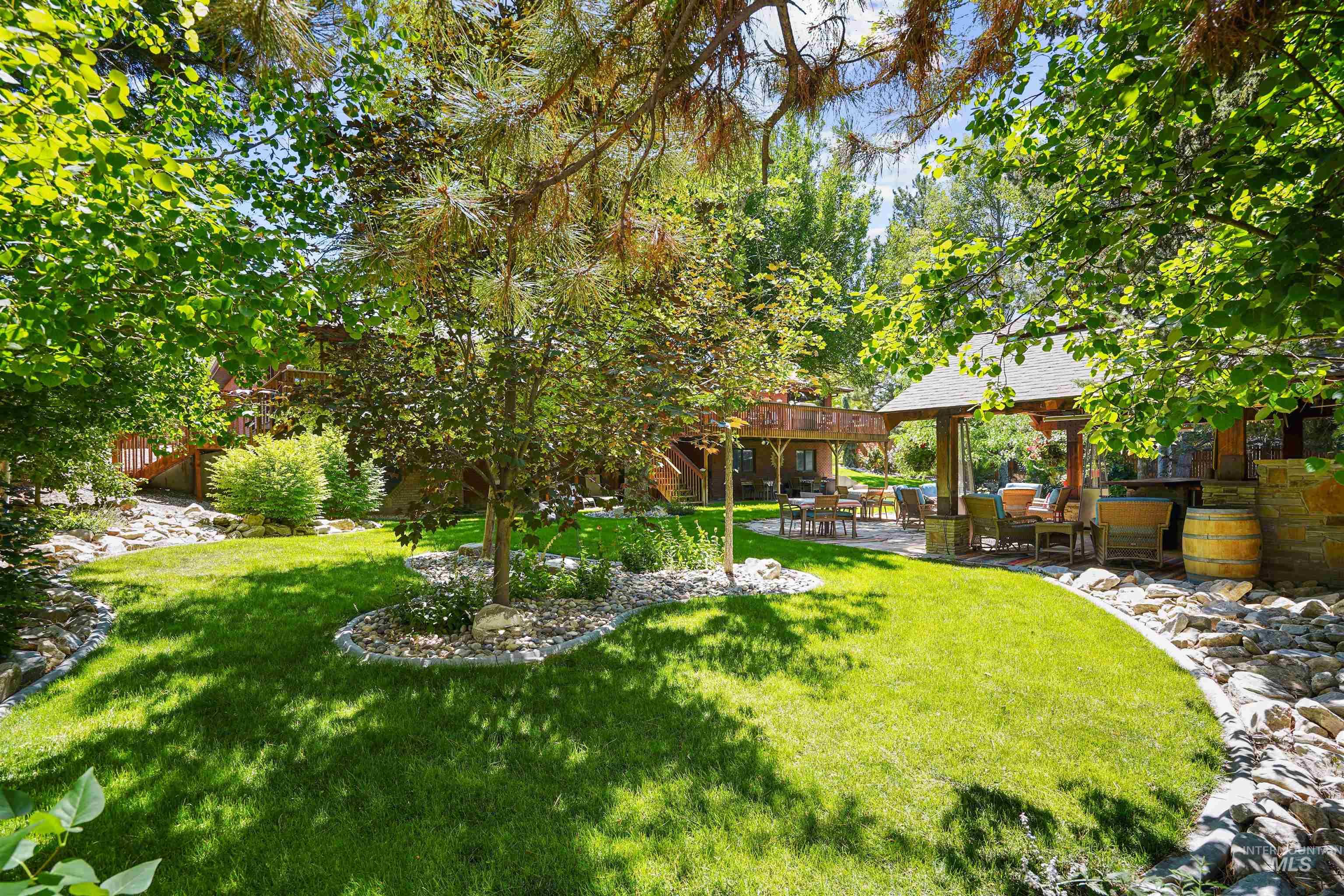 View of green lawn with a patio