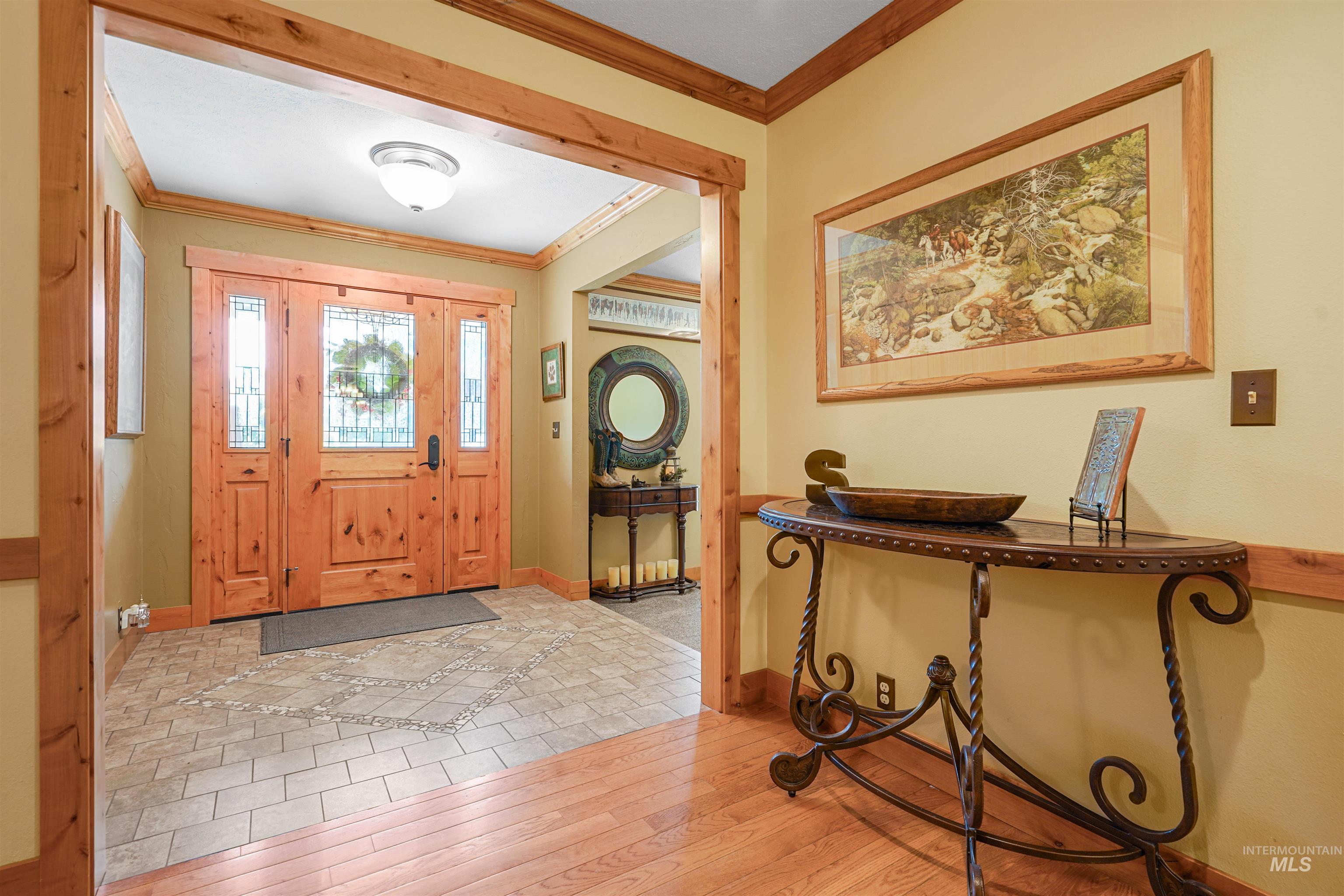 Foyer entrance featuring ornamental molding and hardwood / wood-style floors