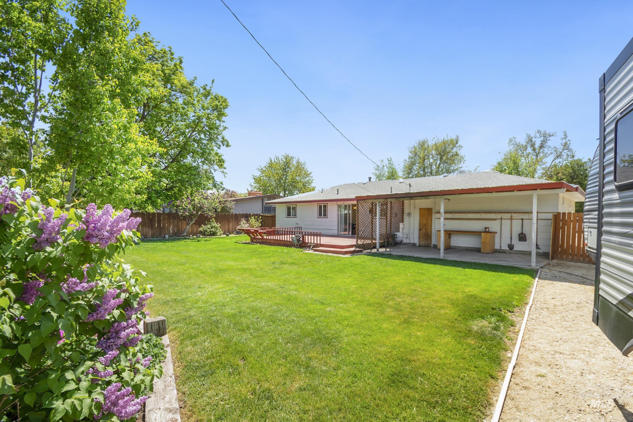 Rear view of property featuring a fenced backyard and a deck